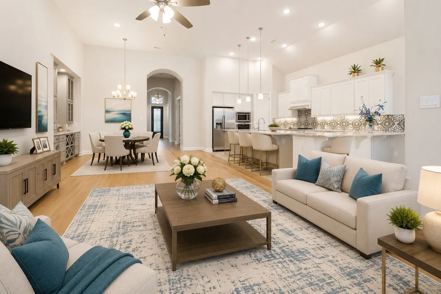 Open-concept living space featuring wood-finish flooring, vaulted ceilings, and recessed lighting