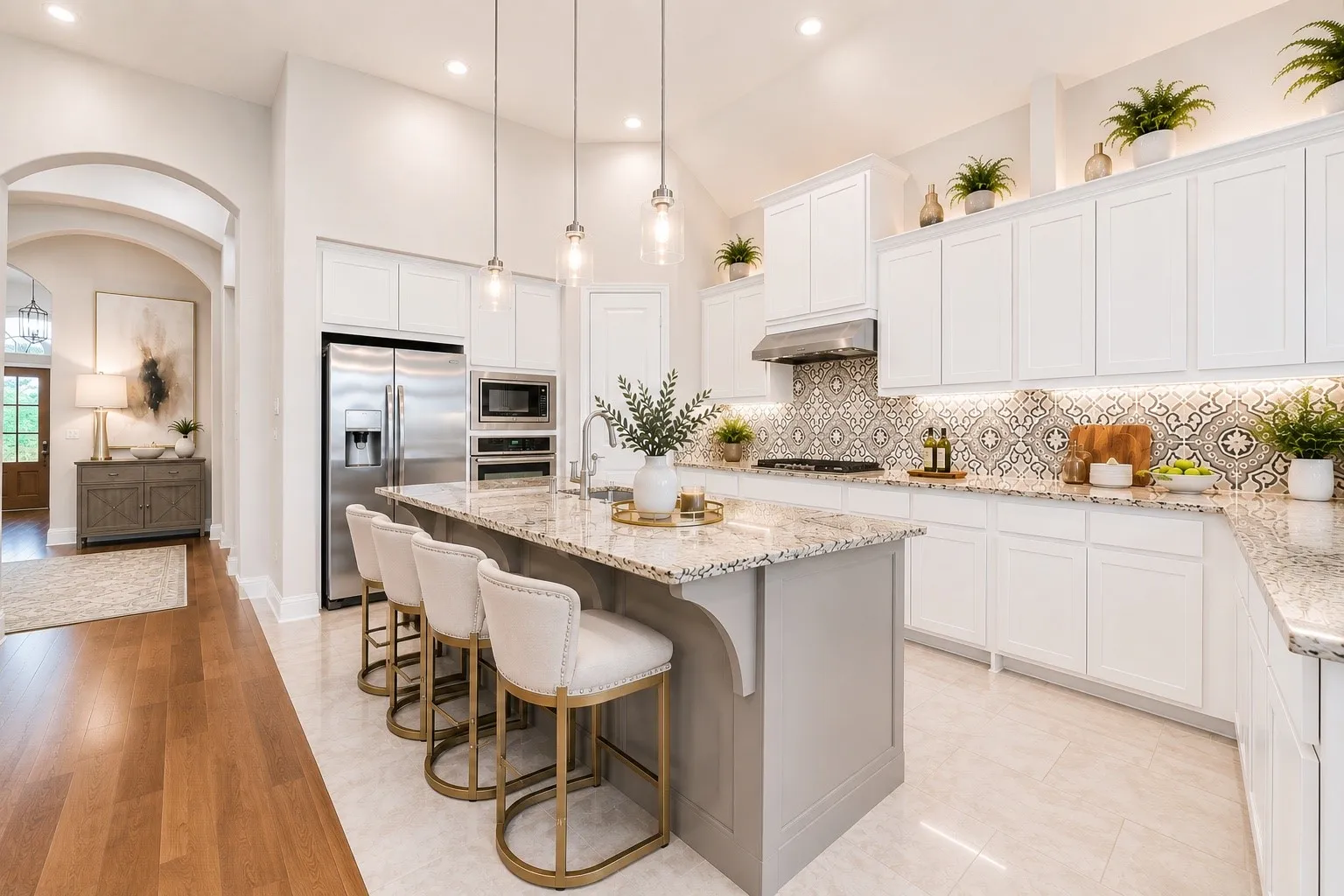 Spacious kitchen featuring an expansive island with seating, white shaker cabinetry, stainless steel appliances, and a decorative tile backsplash
