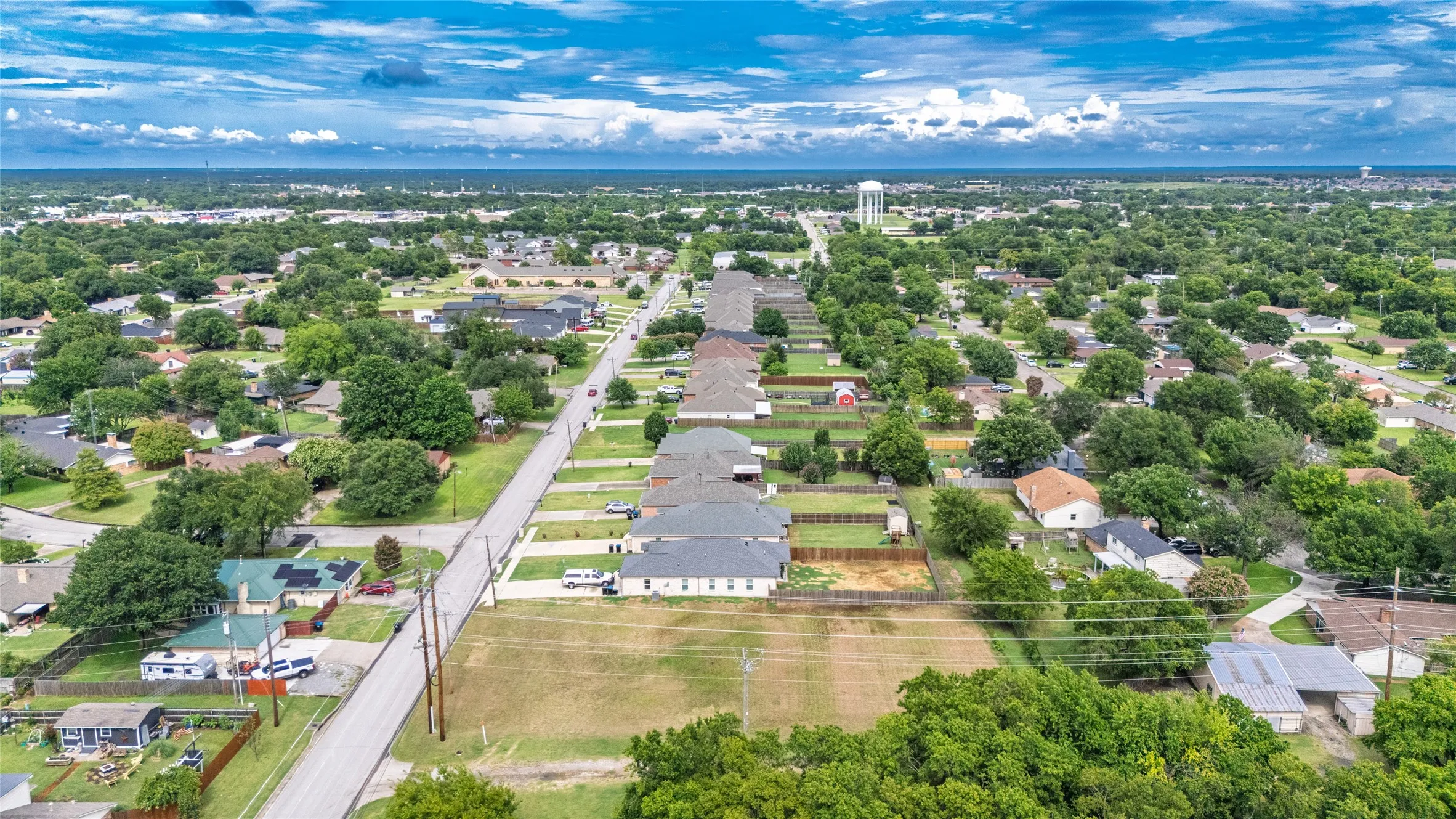 Aerial perspective showcasing an established residential neighborhood with mature tree coverage