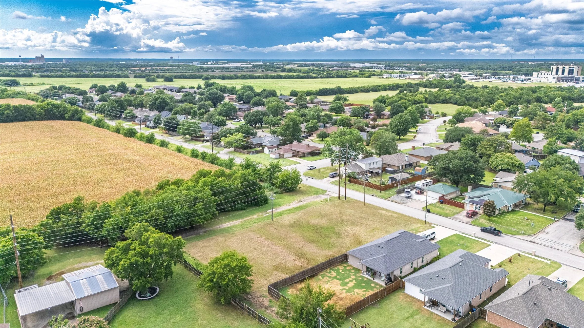 Expansive lot featuring a grassed area and perimeter fencing