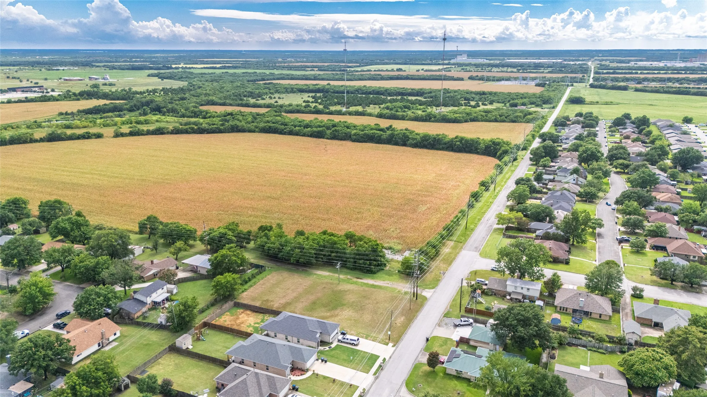 Aerial perspective showcasing a residential street with single-story homes and mature trees