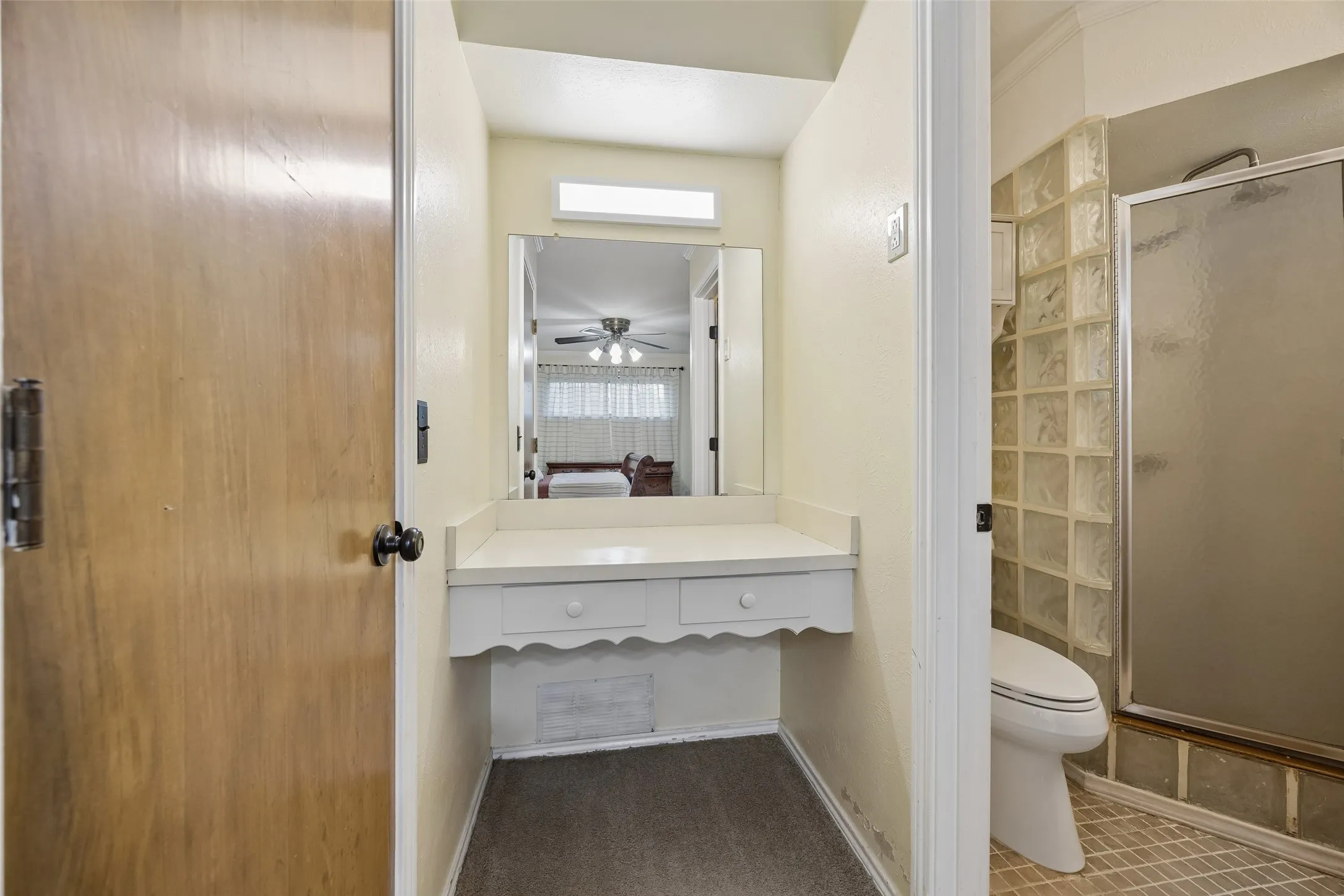 Built-in vanity with mirror and overhead lighting