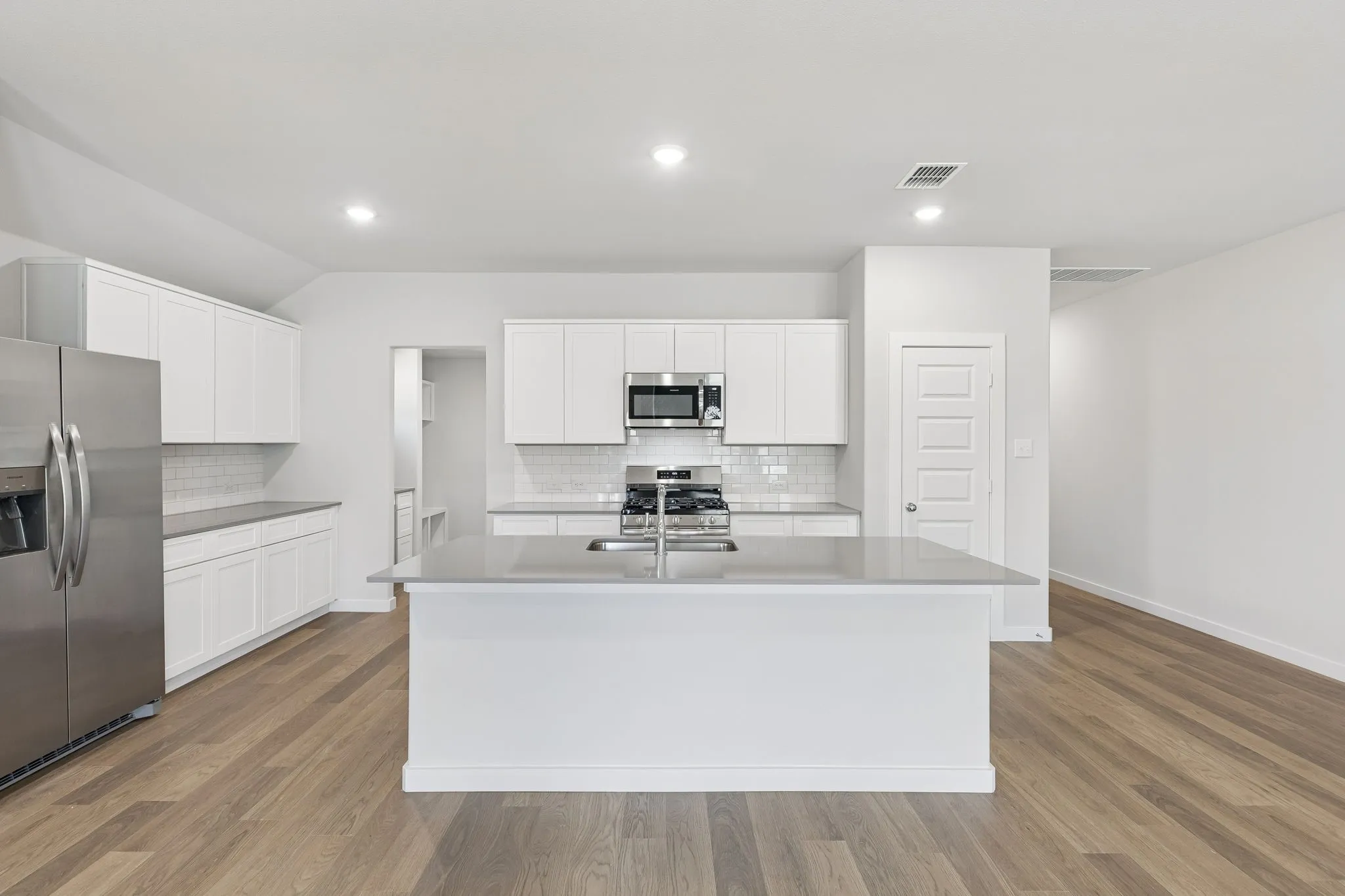 Kitchen in the Harrison home plan by Trophy Signature Homes – REPRESENTATIVE PHOTO