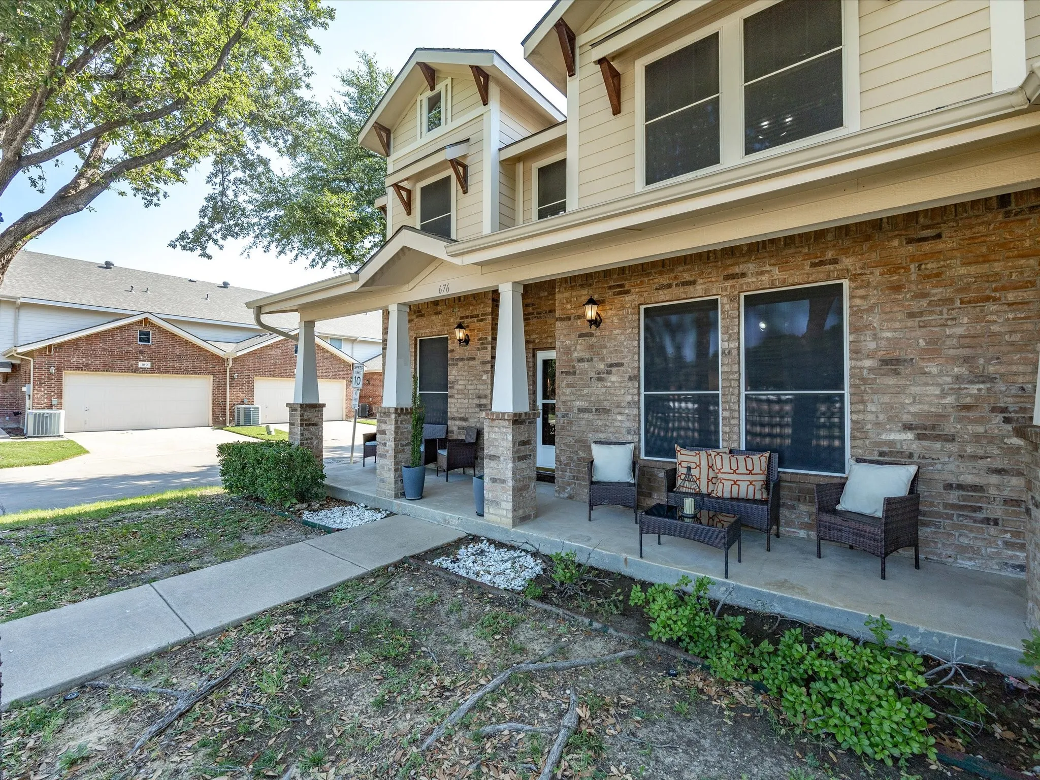 Brick exterior with an attached garage, featuring a panel-style garage door