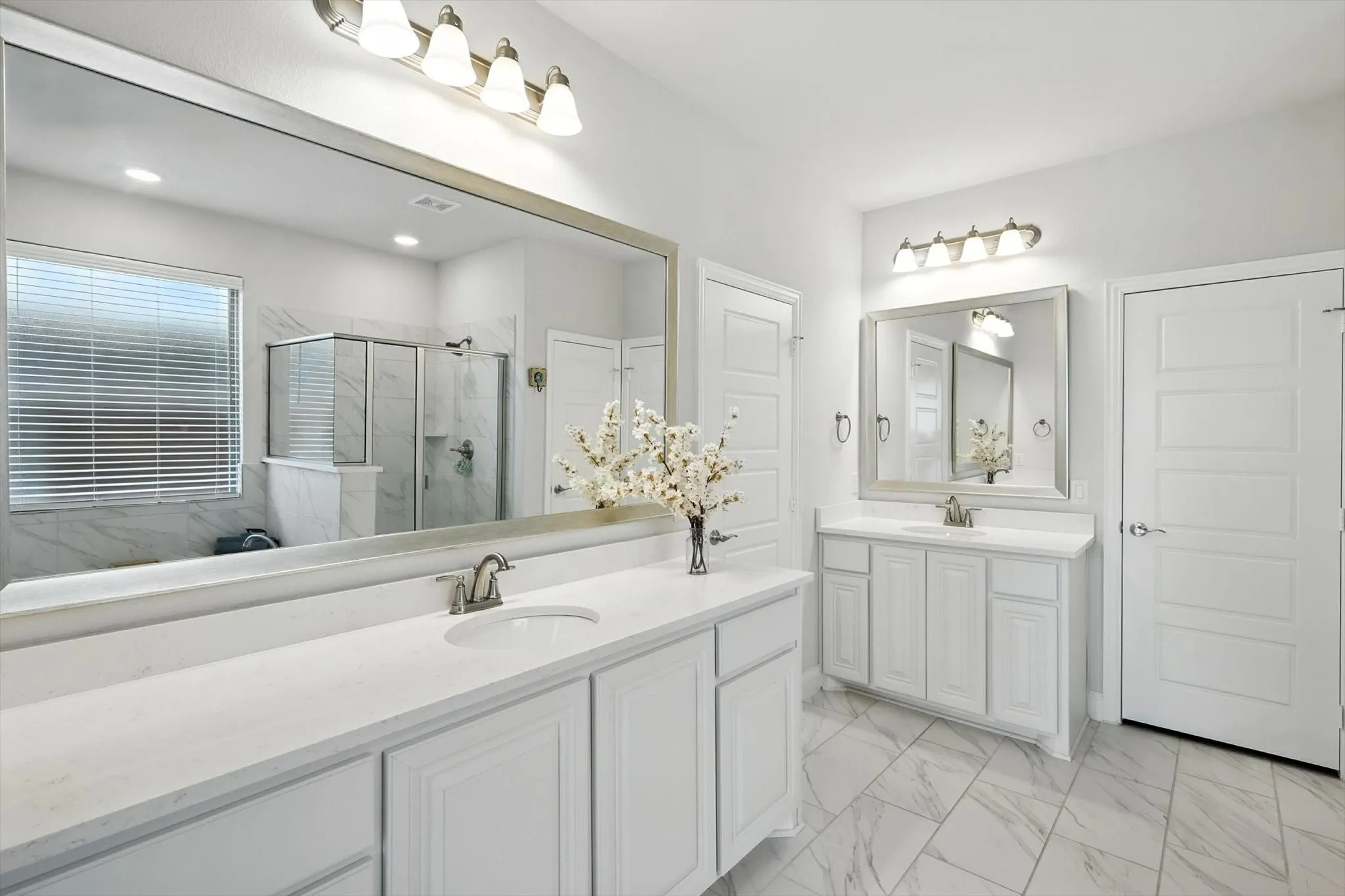 Primary Bathroom with soaking tub, separate shower, and dual vanities
