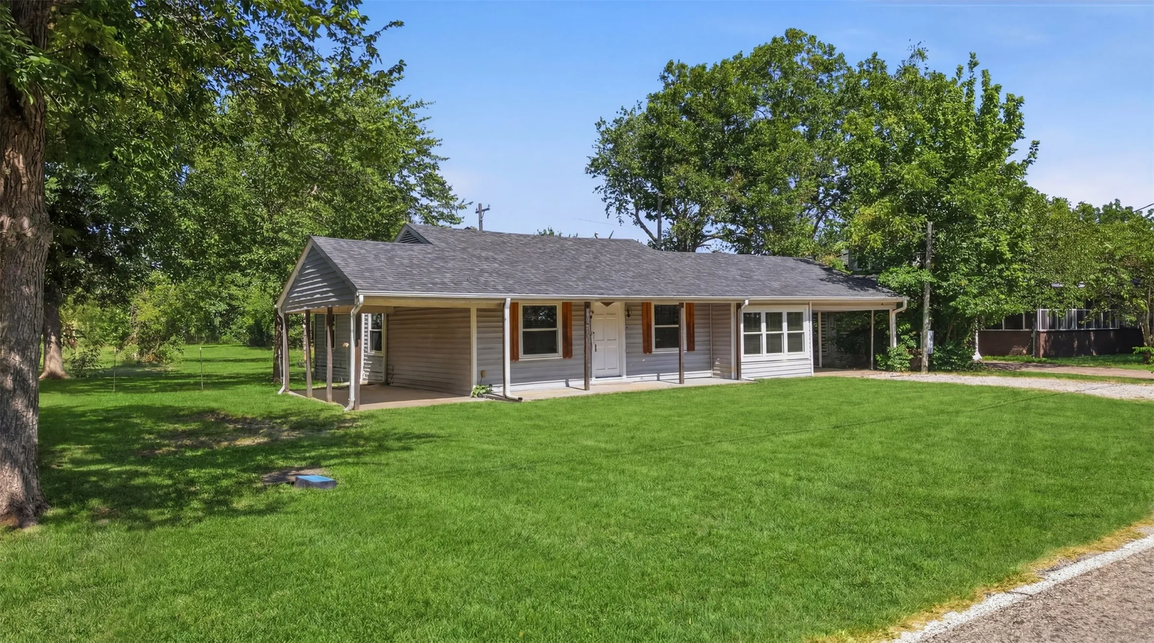 Light gray siding exterior with dark gray shingle roofing