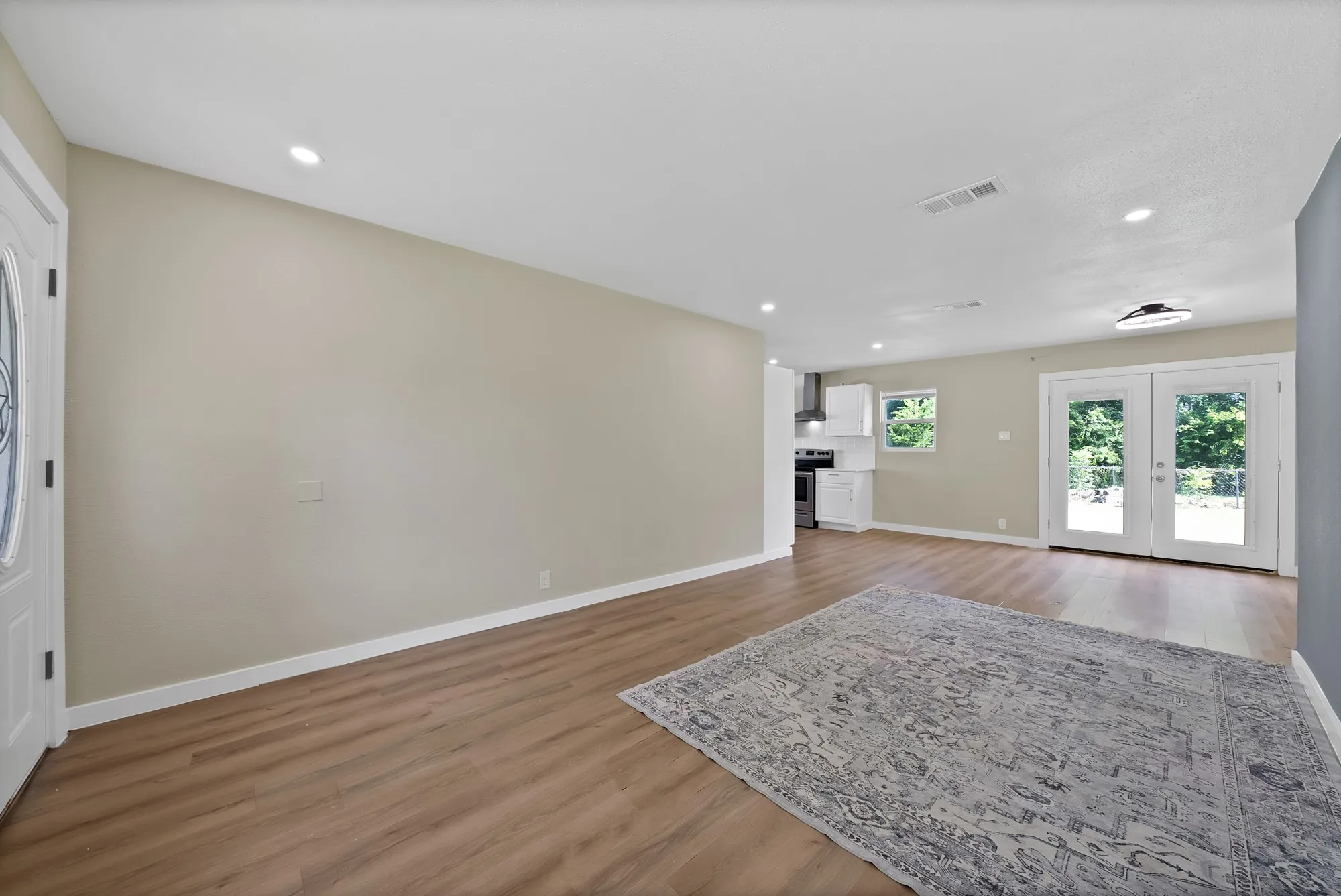 Spacious interior featuring wood-finish flooring, recessed lighting, and a neutral wall palette