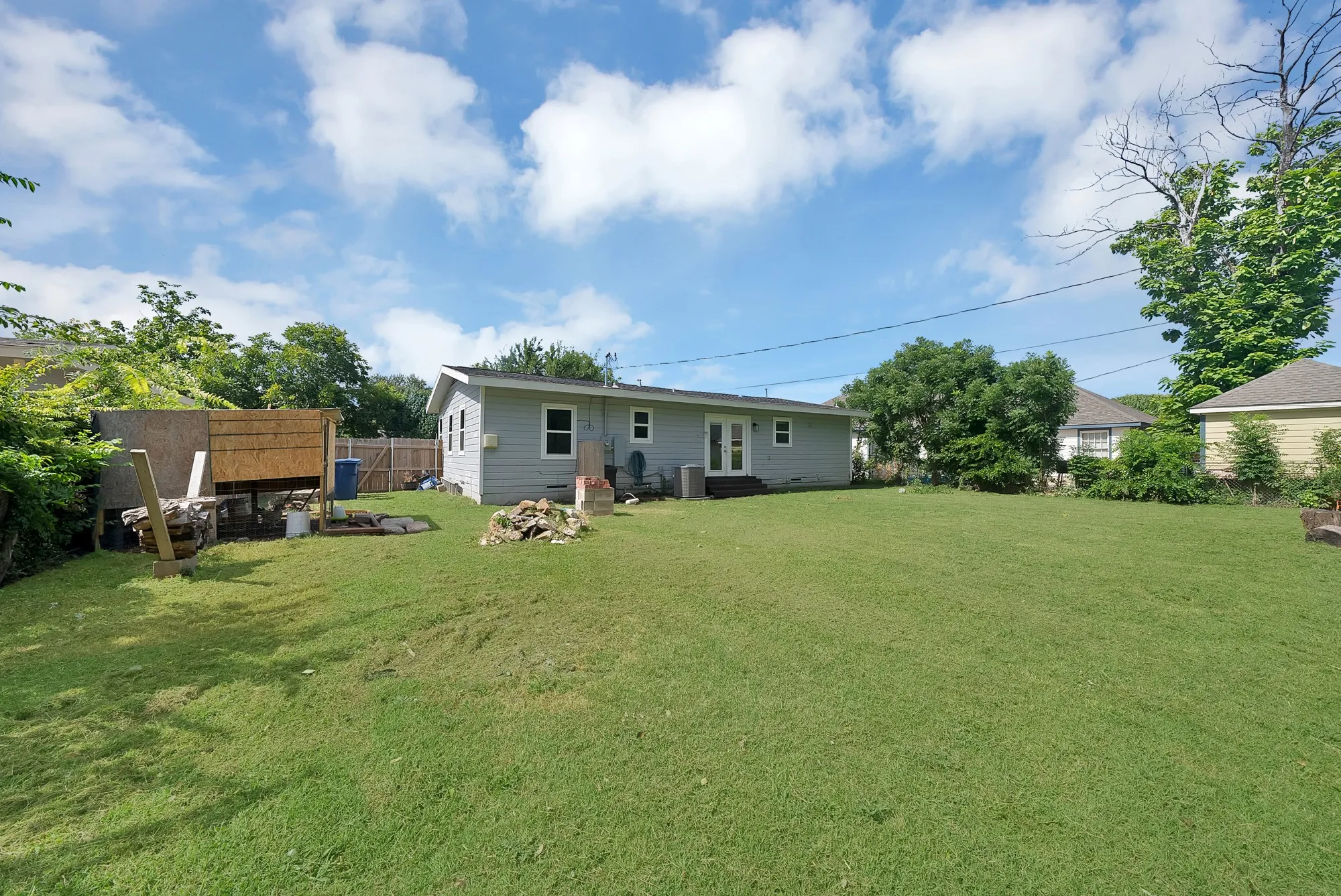 Expansive rear yard featuring a manicured lawn