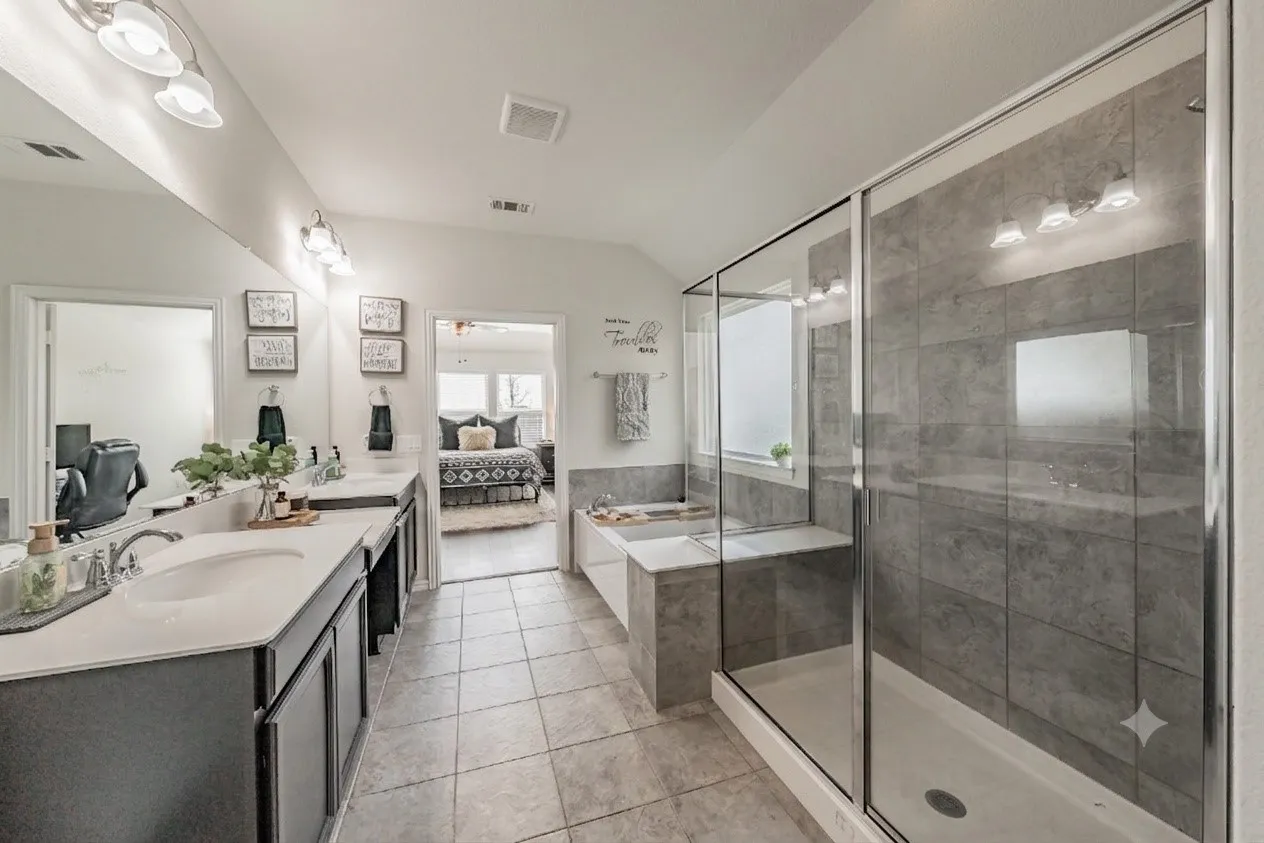 Primary ensuite bathroom featuring dual sinks, seperate oversized shower and soaking garden tub