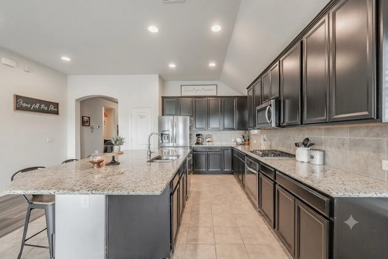Chef's dream kitchen, featurig stainless steel appliances with gas stove, ample countertop space with abundance of storage