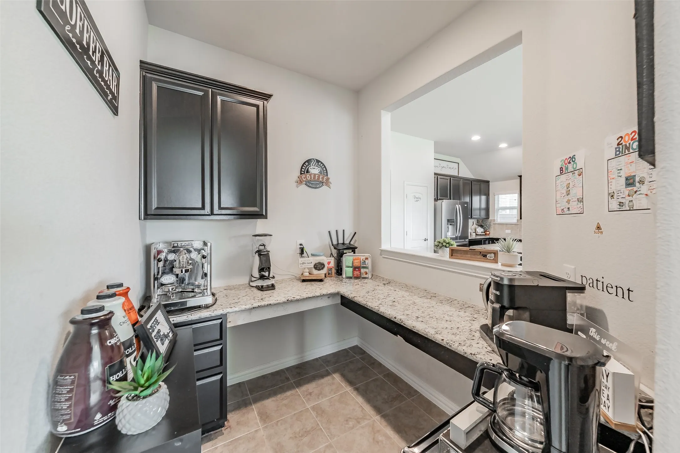 The center of home features a cute office/study nook, coffee bar, or flex space with endless options of use! Featring built in cabinets, drawers and desk area