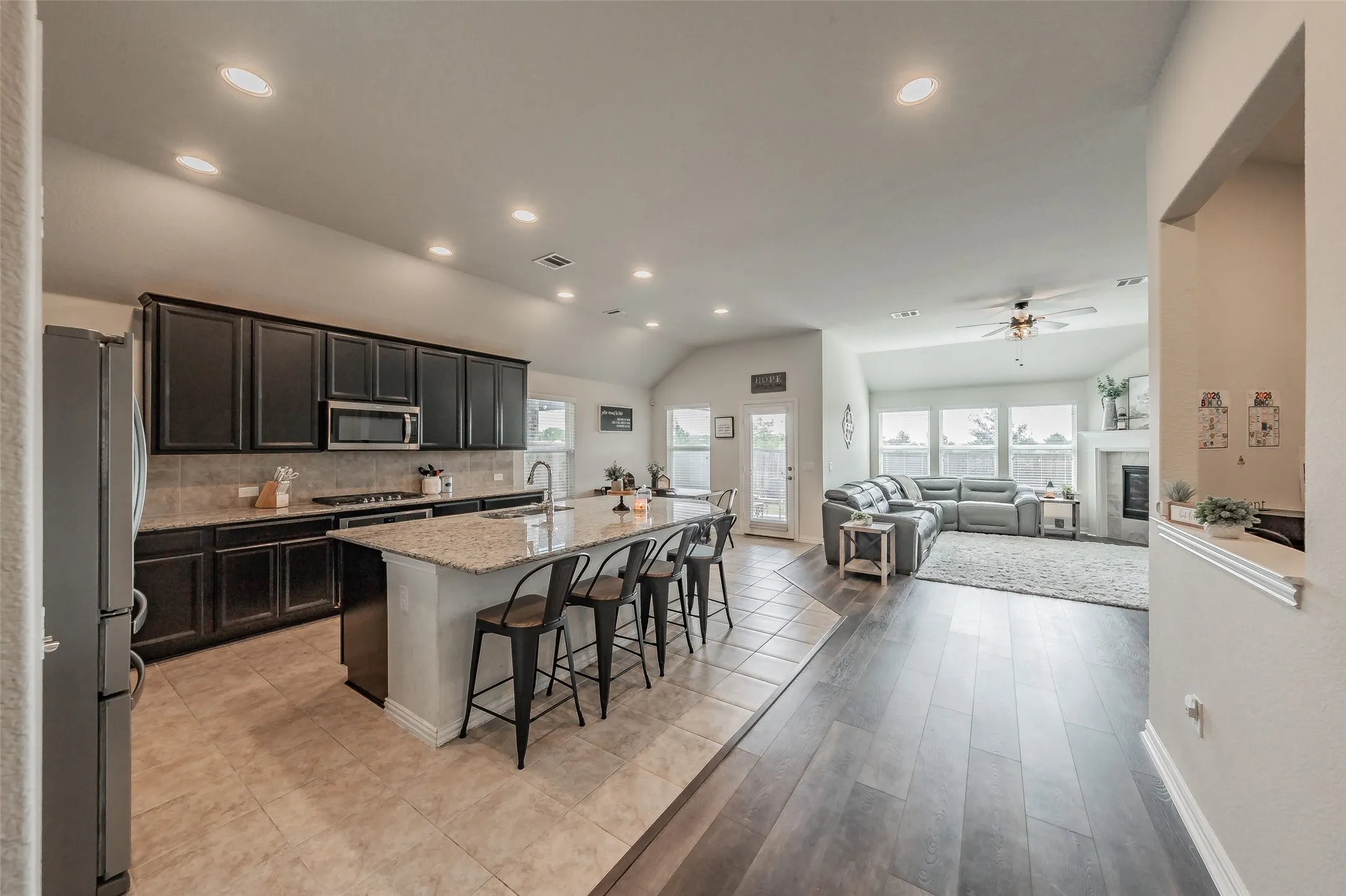 Open-concept kitchen featuring a spacious kitchen island with seating