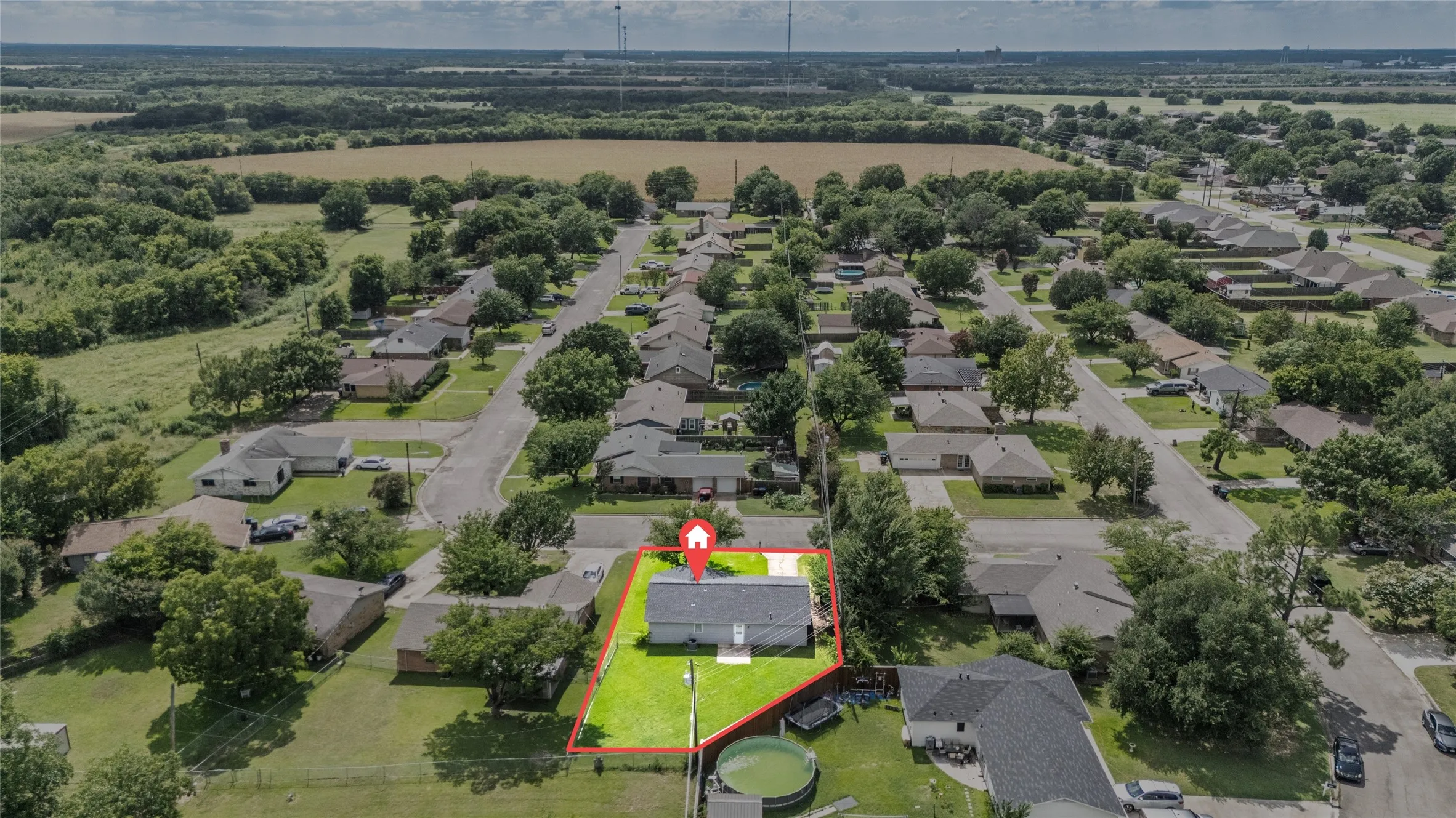 Aerial perspective showcasing the property within a residential neighborhood
