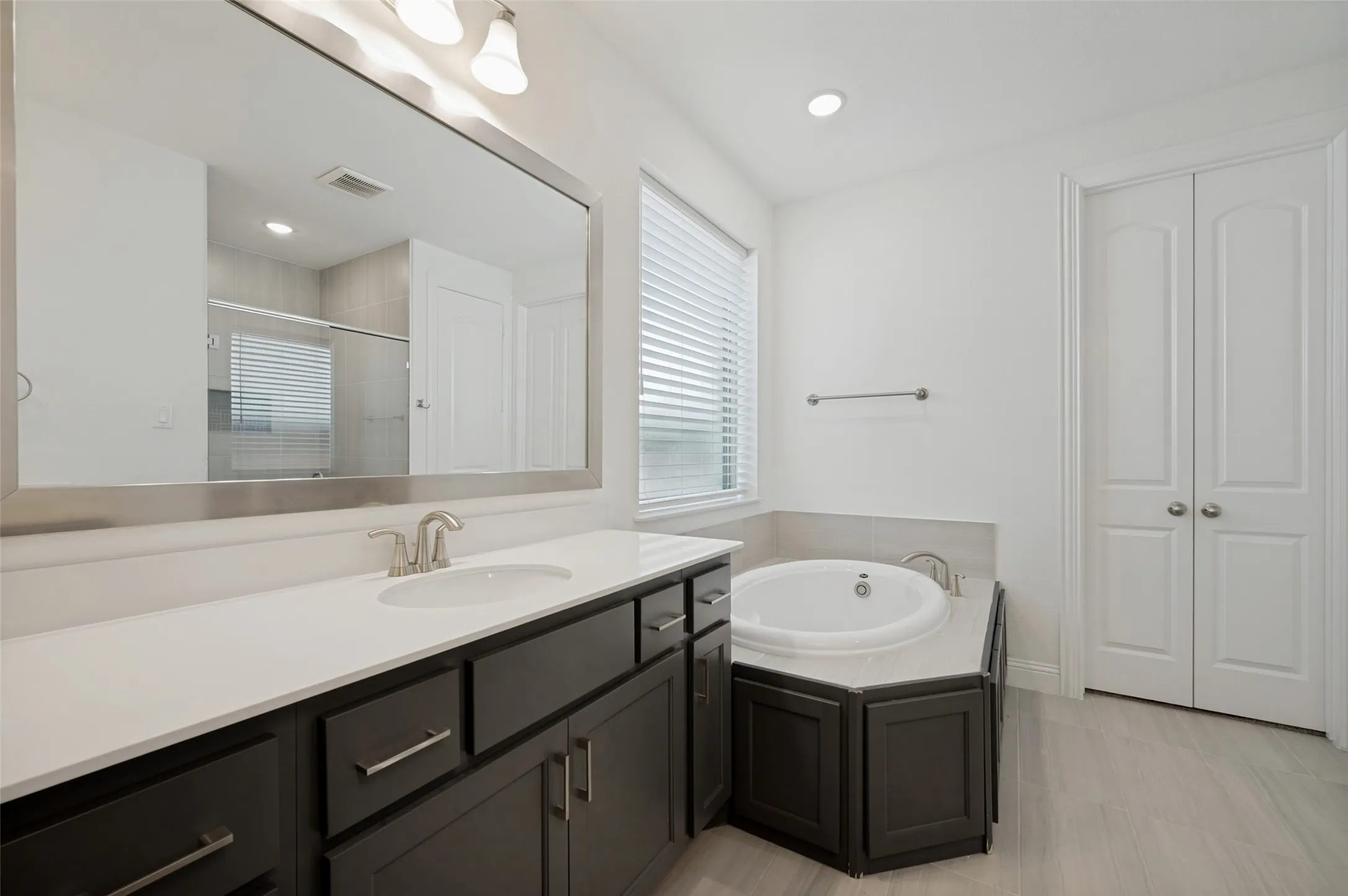 Primary bath also includes an oversized shower and large walk-in closet