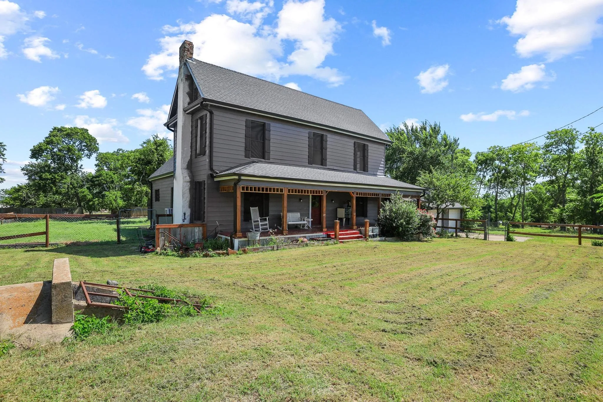 Two-story residence featuring grey siding and a dark shingle roof