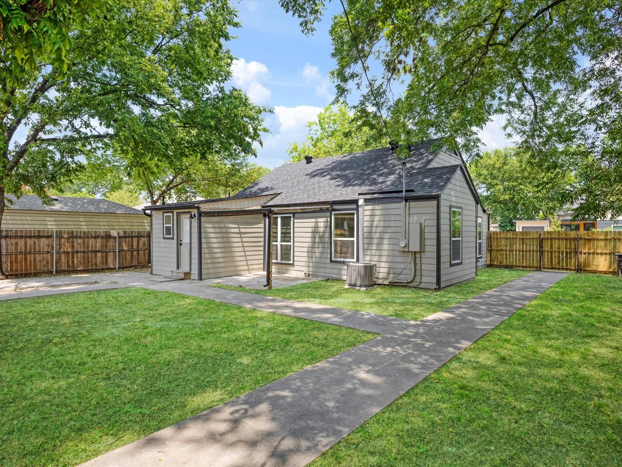 Exterior featuring gray horizontal siding and dark trim