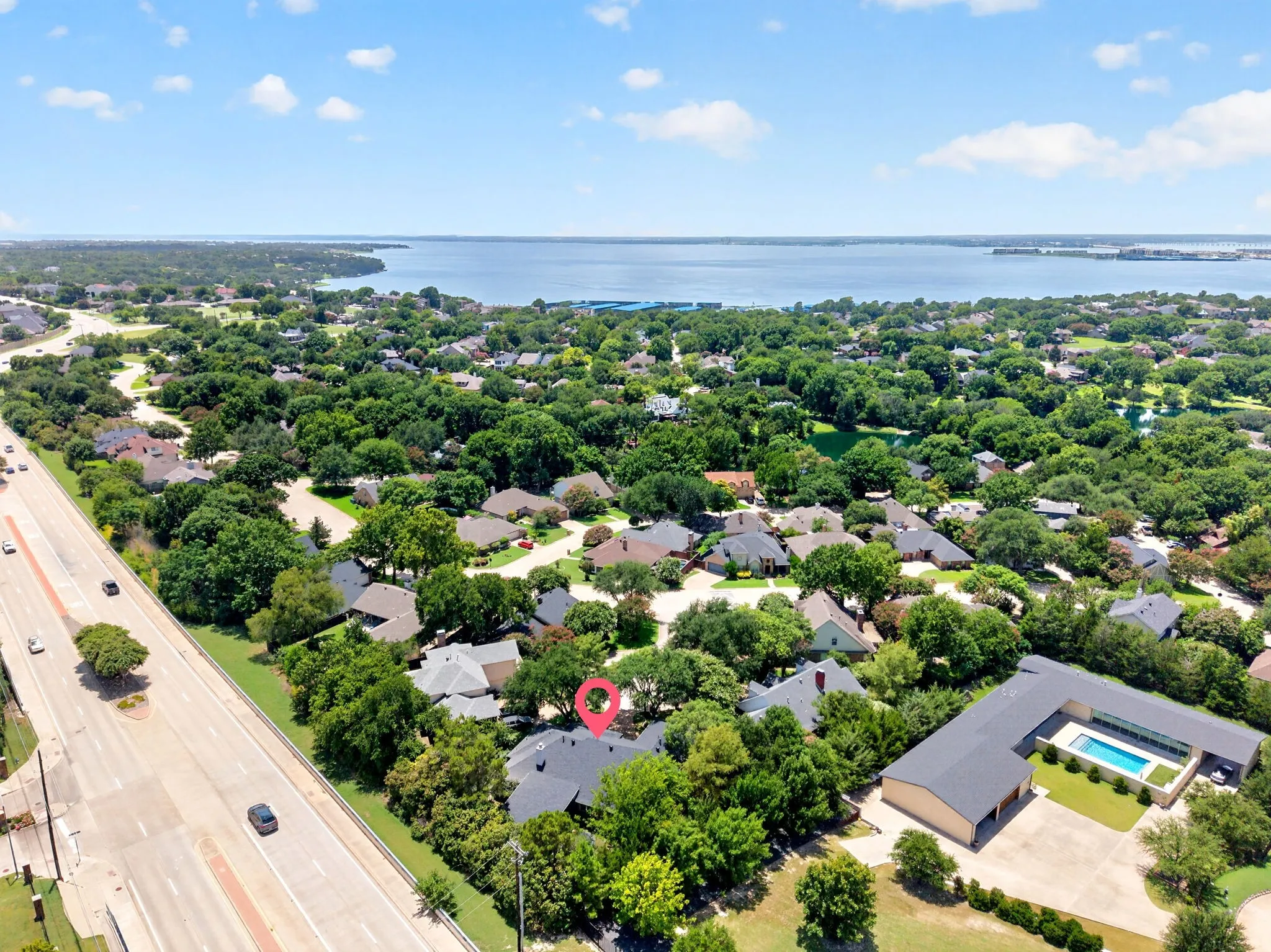 Aerial perspective showcasing a residential area with a prominent body of water in the background