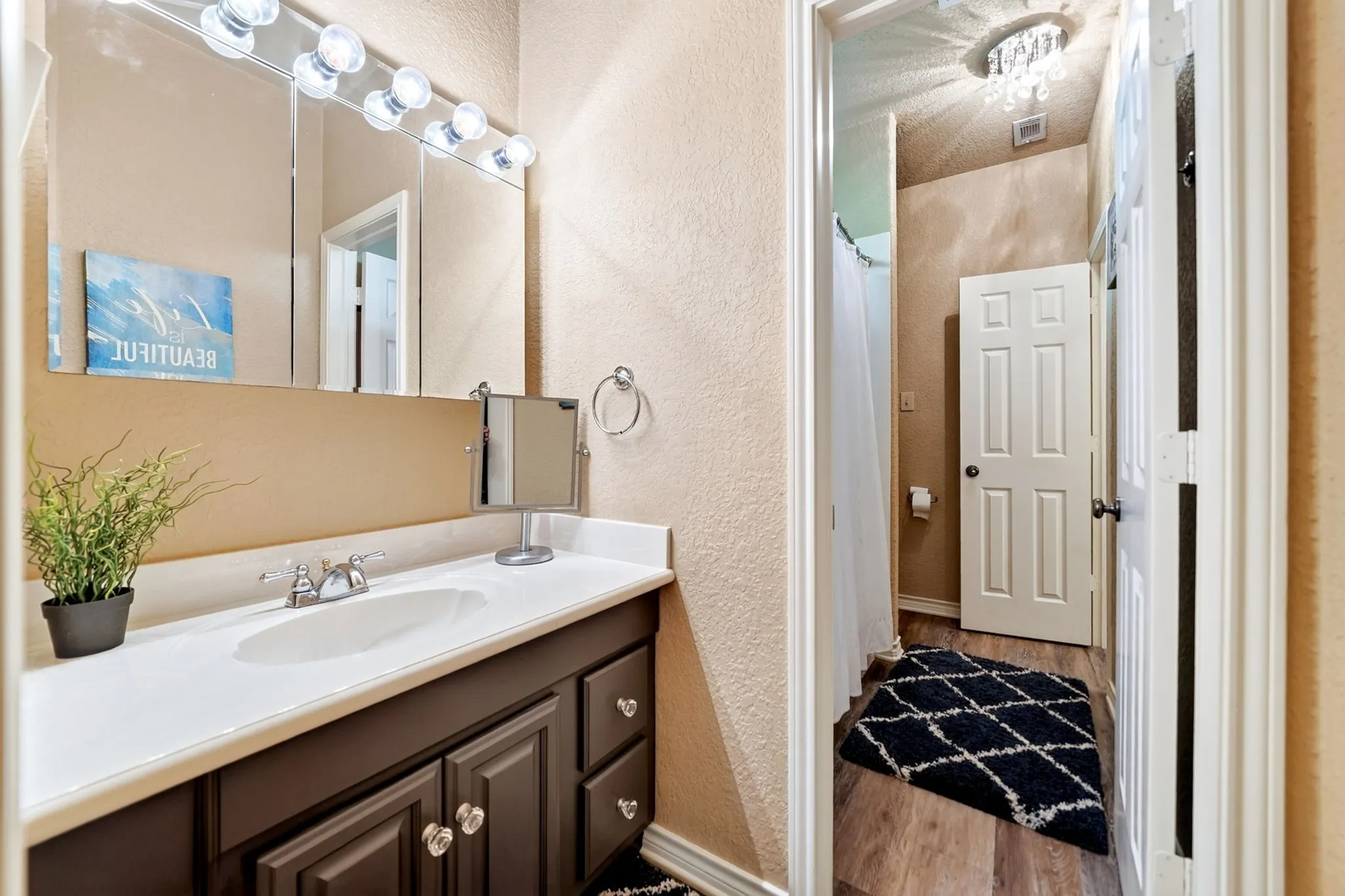 Vanity area featuring a built-in sink, dark wood-finish cabinetry, and a white countertop