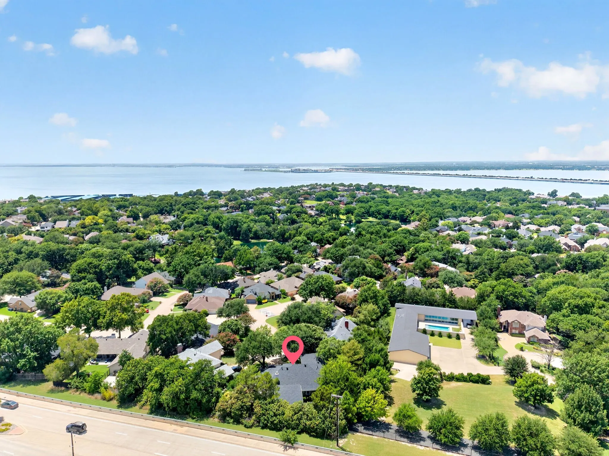 Aerial perspective showcasing a residential area with a prominent body of water in the background