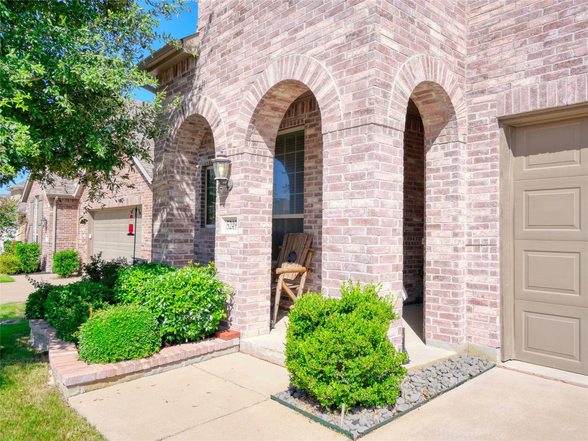 Brick facade with arched entryways and a covered porch
