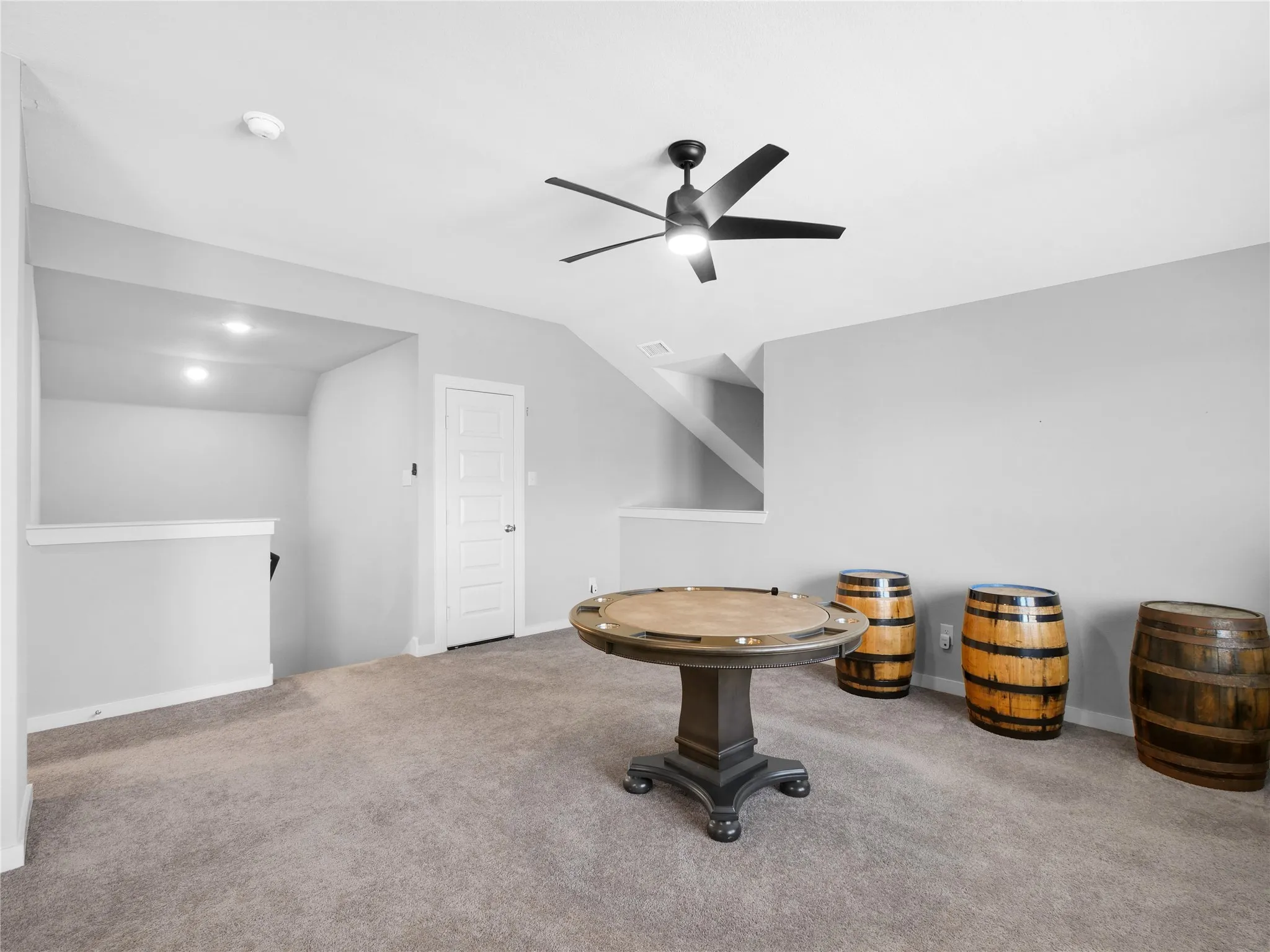 Carpeted room with recessed lighting and light gray walls