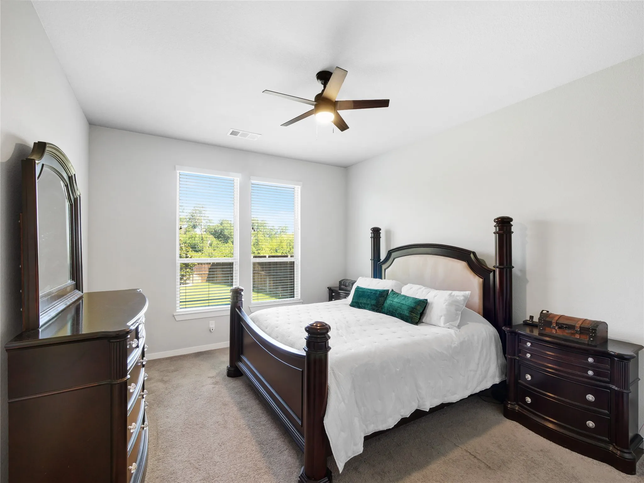 Bright interior featuring dual windows, neutral wall tones, plush carpet flooring, a ceiling fan, and recessed lighting