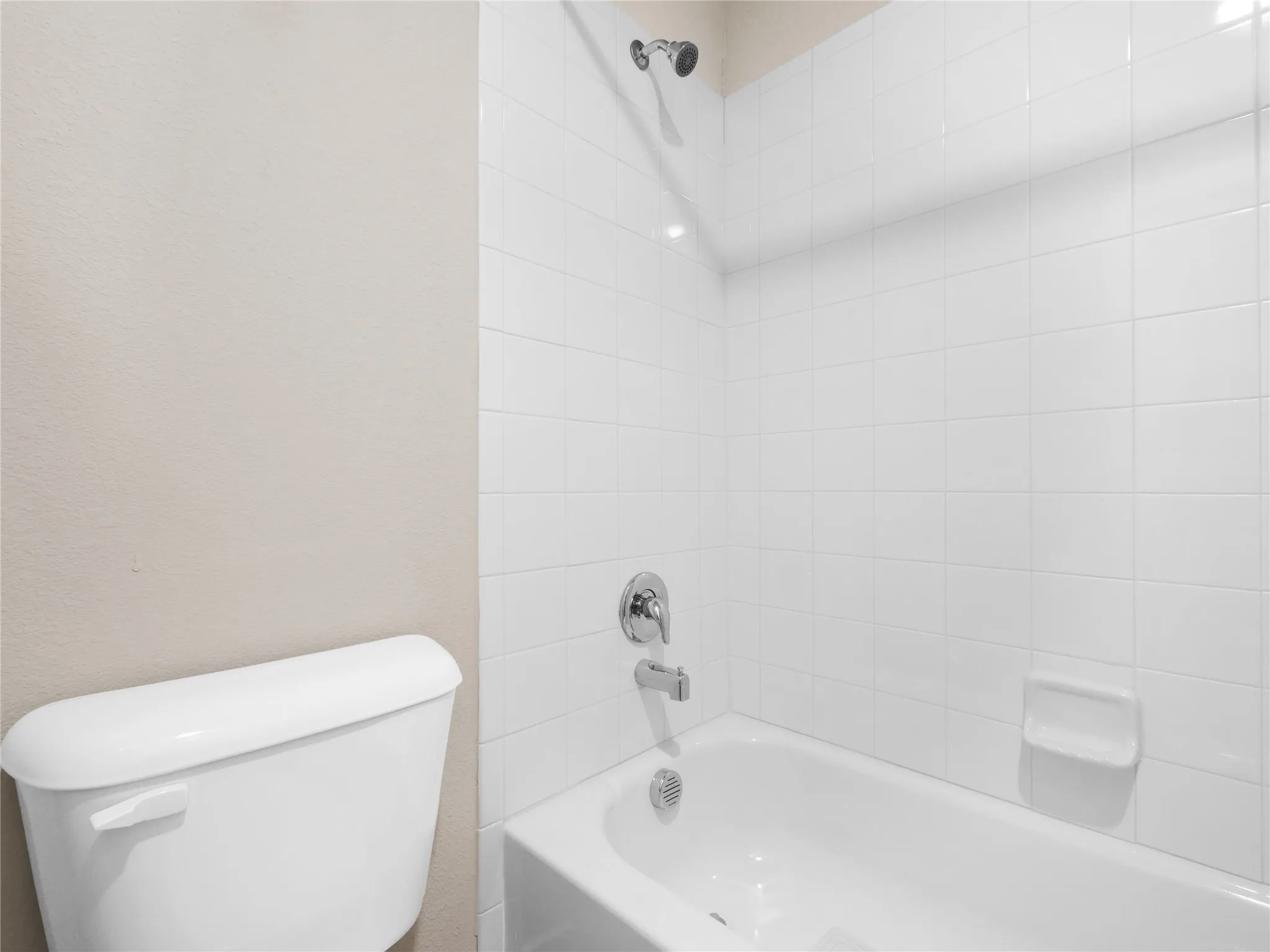 2nd Floor Bathtub and shower combination featuring white subway tile surround, chrome fixtures, and a neutral wall color