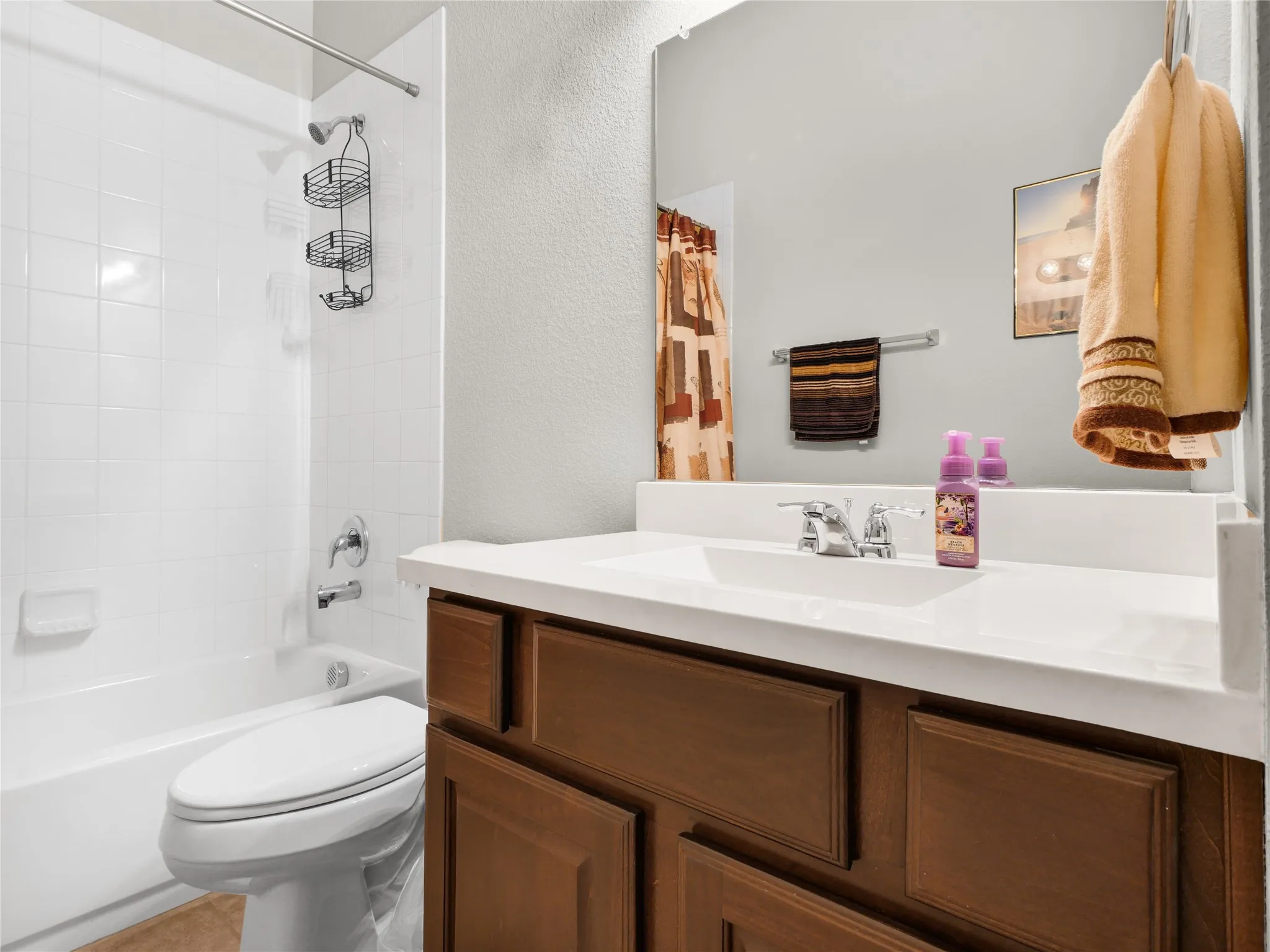 1st Floor Bathroom featuring a dark wood-finish vanity with a white countertop and integrated sink