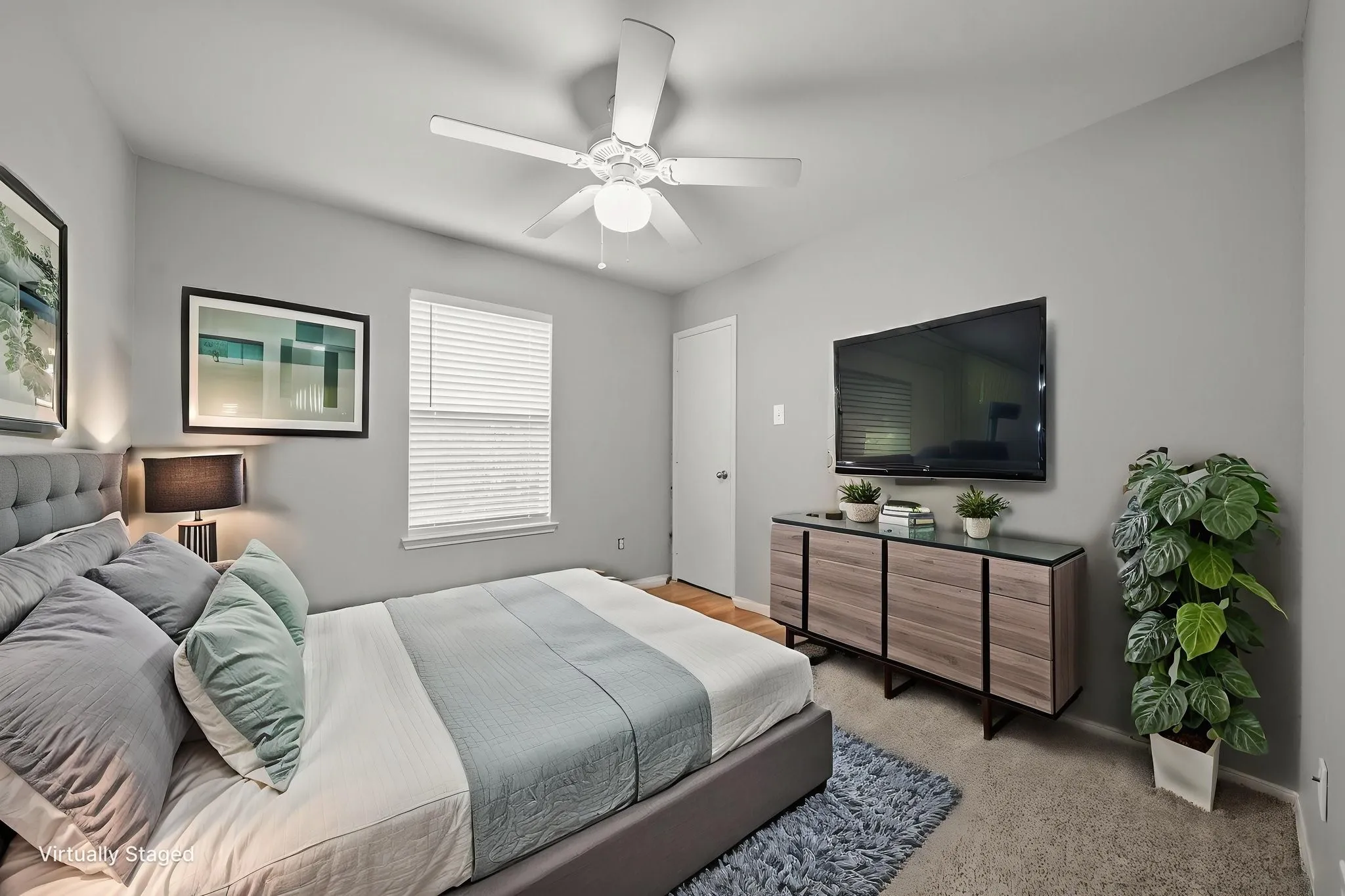 Bedroom featuring neutral wall paint, carpet flooring, a window with horizontal blinds, and a ceiling fan with integrated lighting