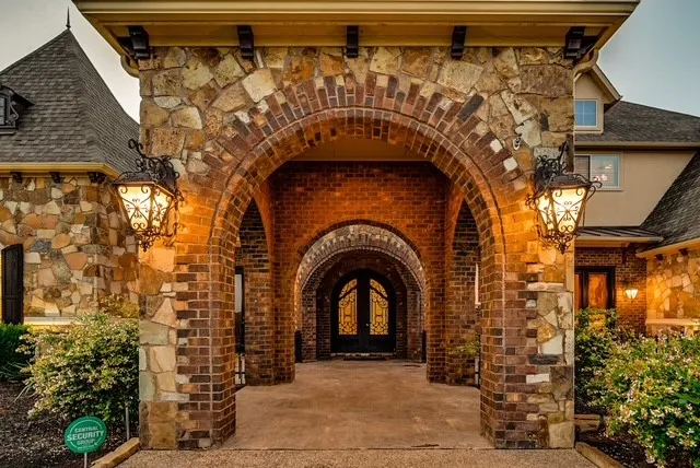 Grand arched entryway featuring brick and stone masonry