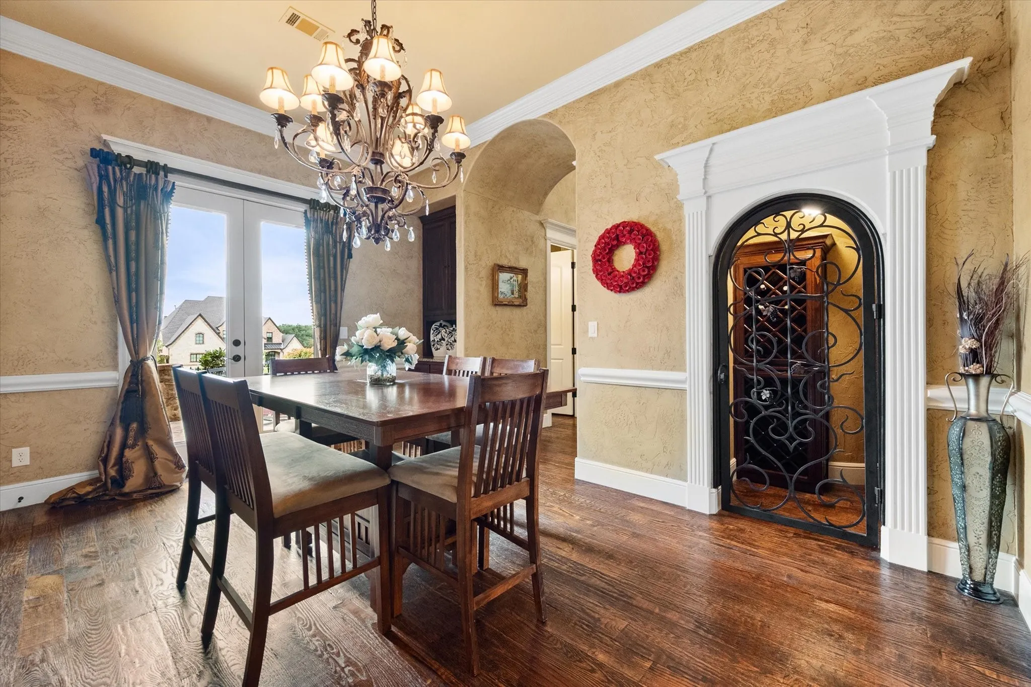 Formal dining space featuring wood-finish flooring and a crystal chandelier
