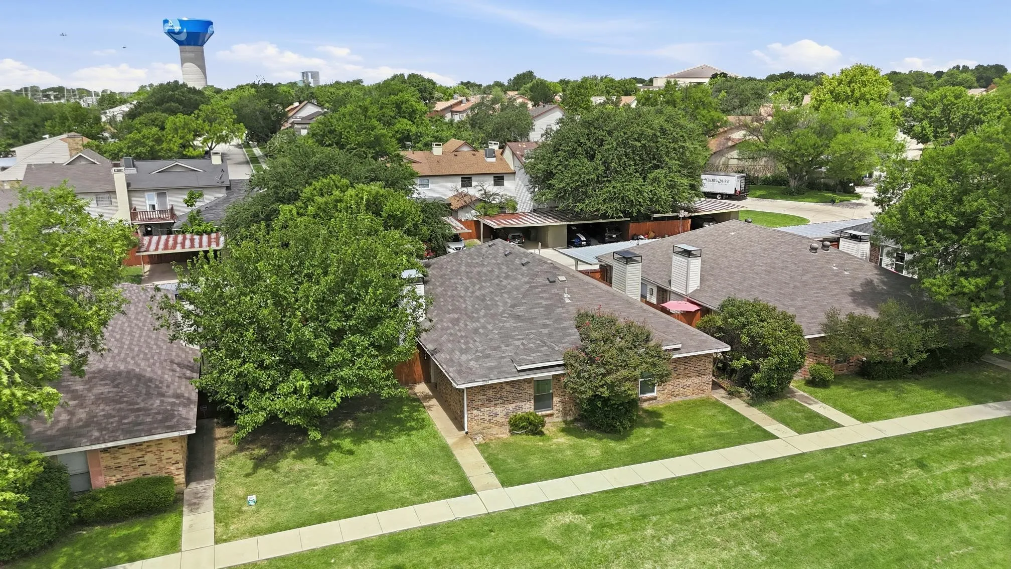 Aerial perspective showcasing residential properties with a water tower in the background