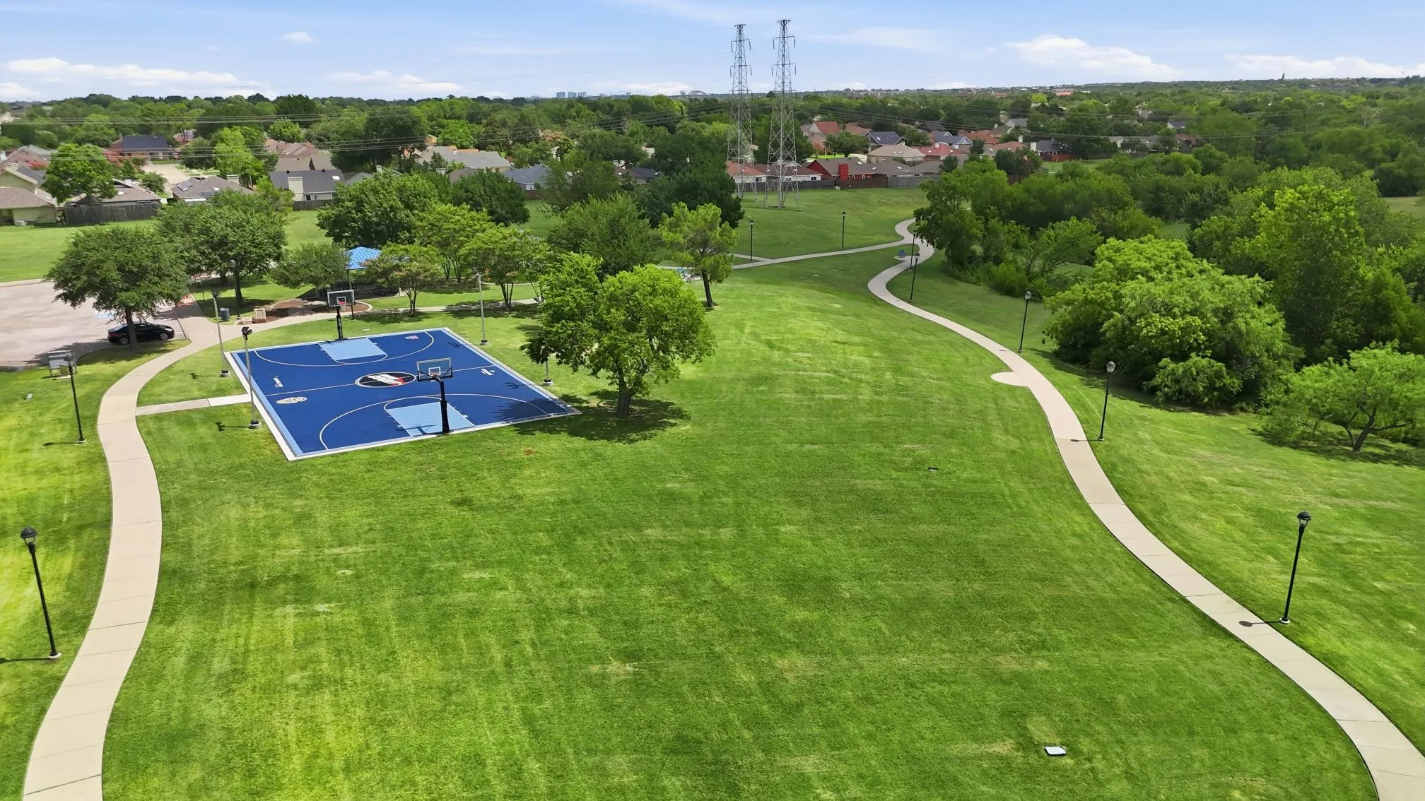 The neighborhood offers beautifully maintained parks, winding walking trails, open green spaces, and a basketball court for year-round outdoor enjoyment.