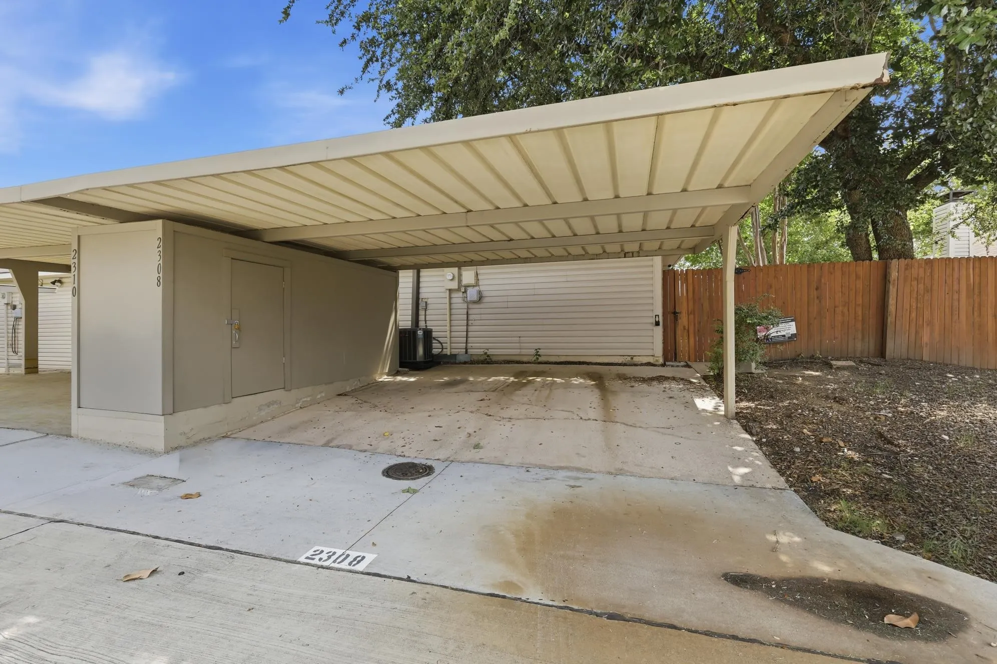 Enjoy the convenience of a spacious covered carport with a secure exterior storage room for tools, bikes, and seasonal items.
