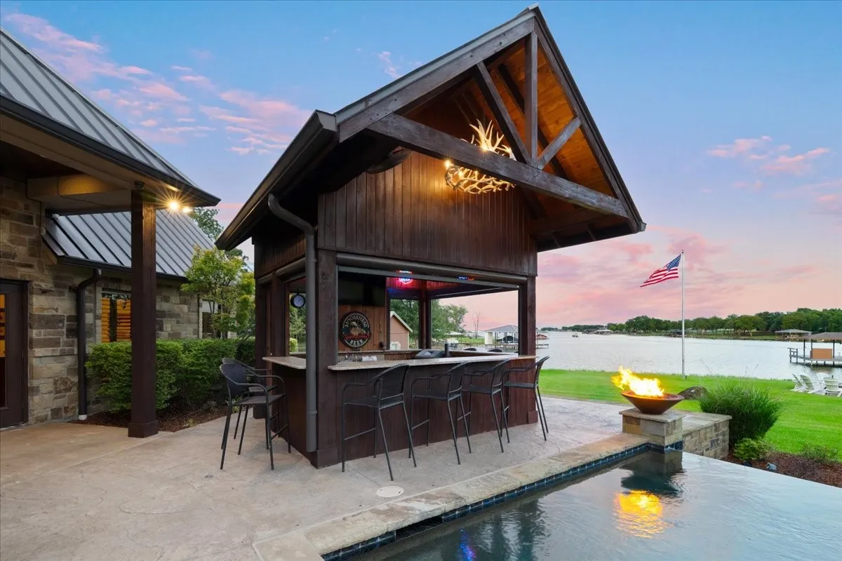 Tiki hut and pool with fire bowls on each end