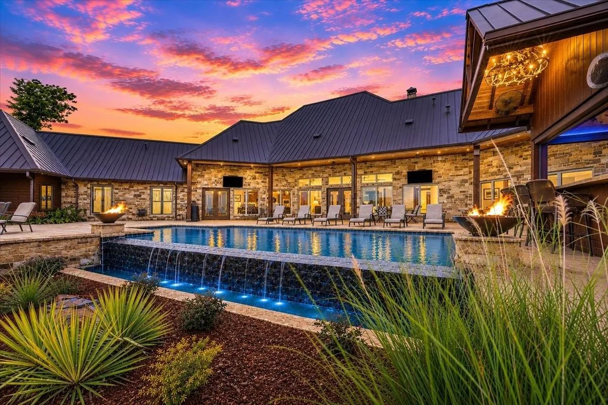 Outdoor resort style pool with fire bowls and tiki hut