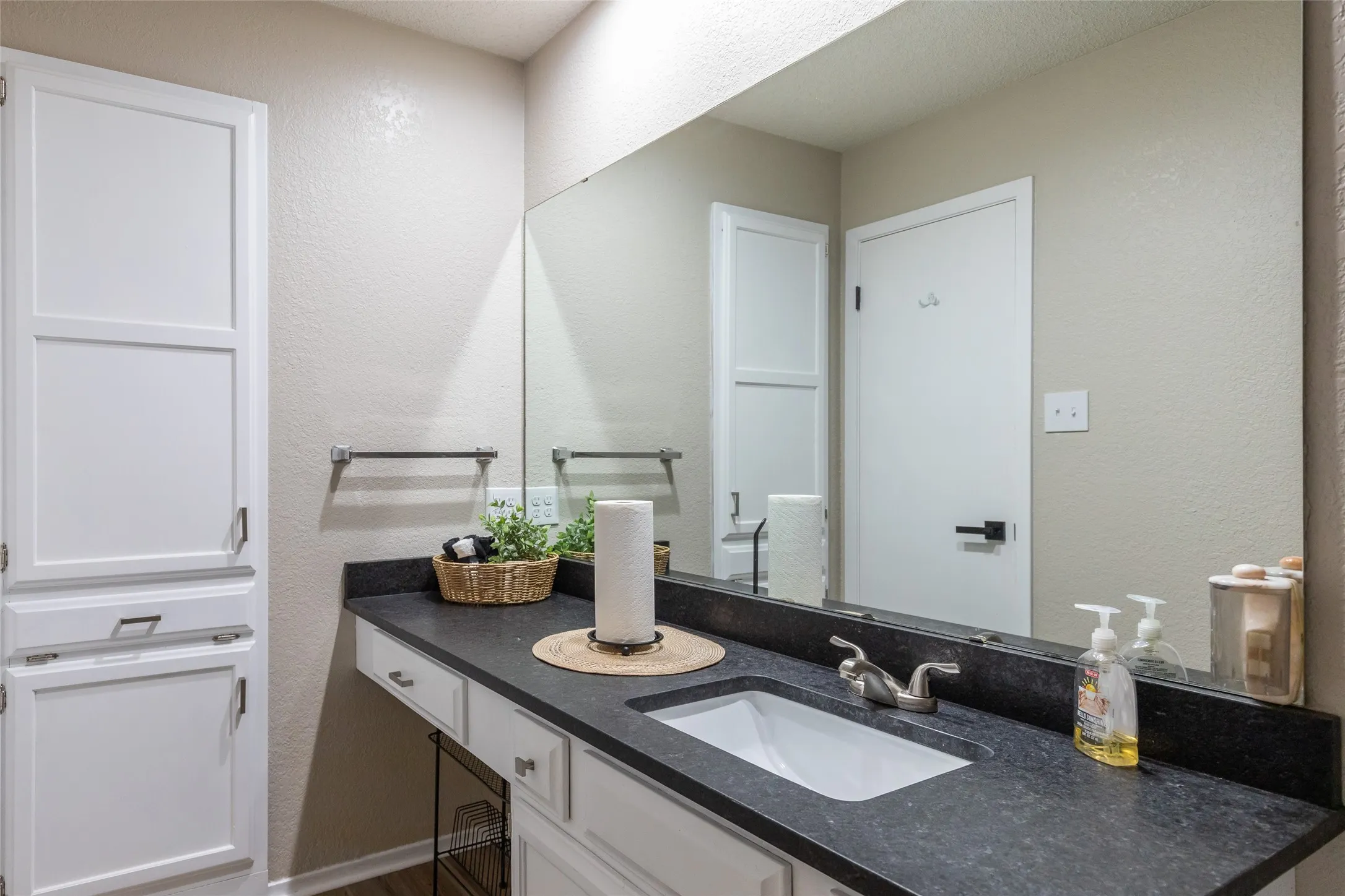 Bathroom 2 vanity featuring a dark countertop with an integrated sink and a chrome-finish faucet