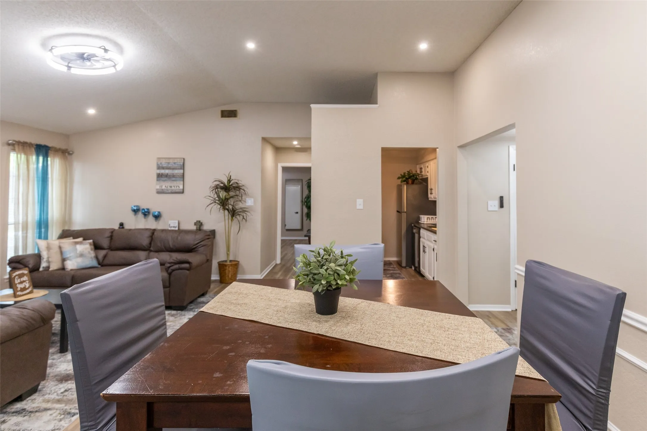 Dining area featuring wood-finish flooring, a recessed ceiling light, and access to the kitchen
