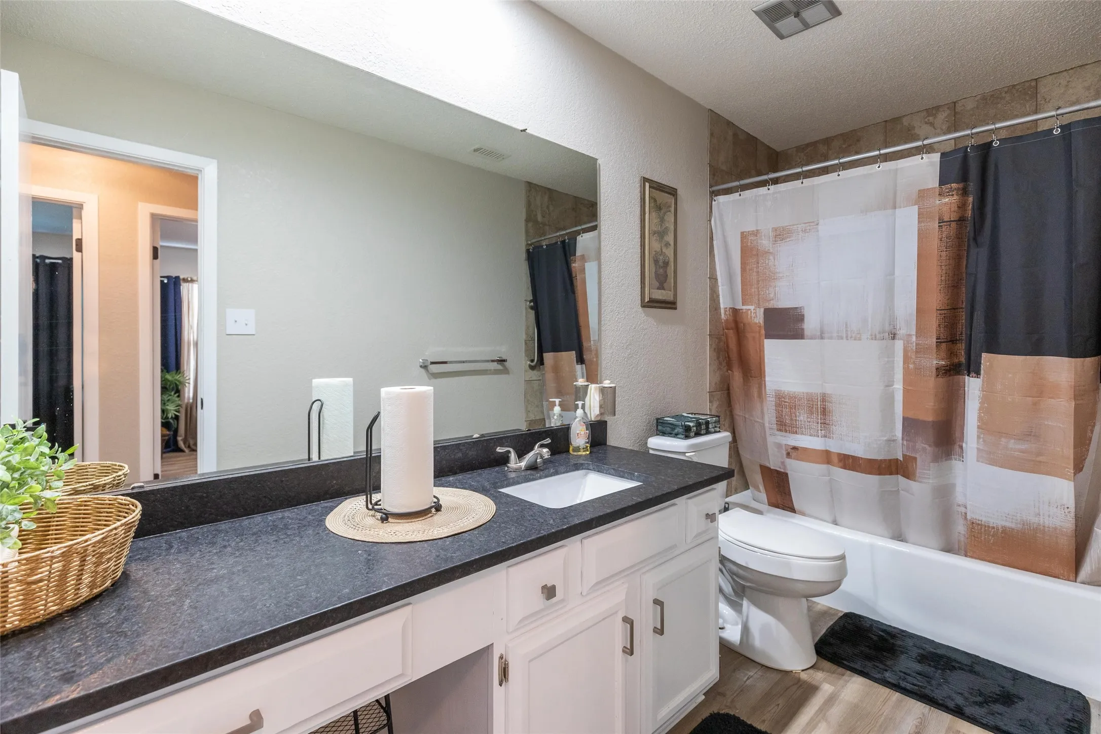 Bathroom 2 bathtub-shower combination featuring neutral-toned tiled surround