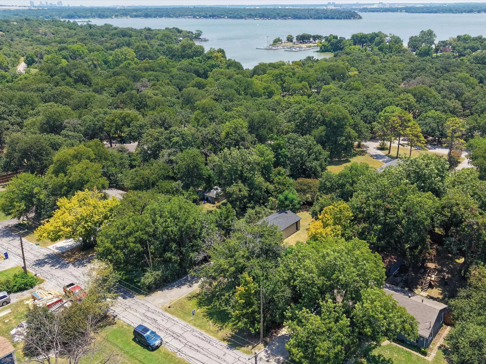 Aerial perspective showcasing a verdant landscape with mature trees surrounding properties
