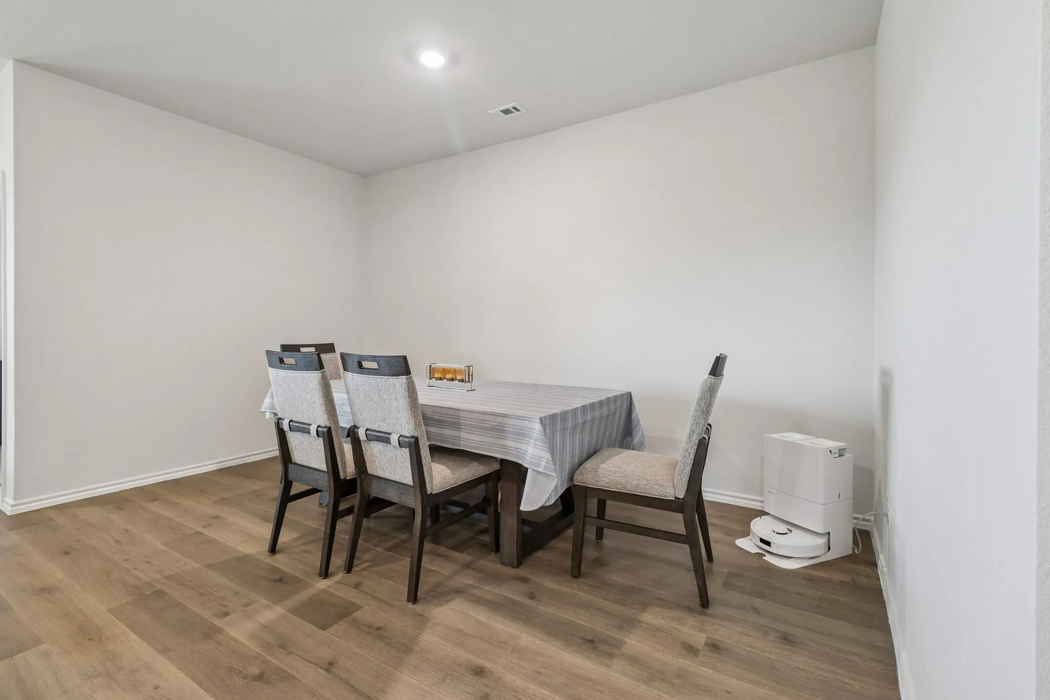 Dining area featuring wood-finish flooring, white baseboards, and a recessed ceiling light