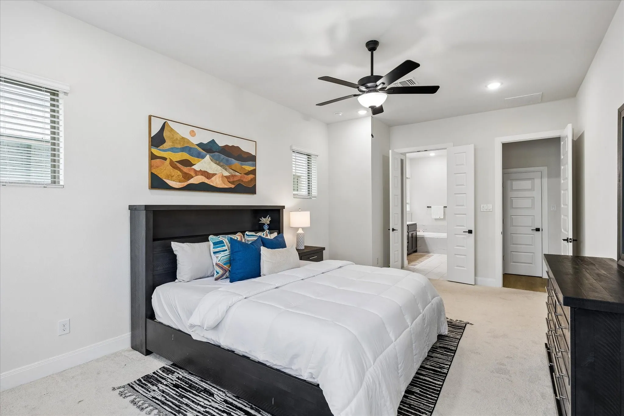 Bedroom with neutral-toned carpeting, a ceiling fan with integrated lighting, and recessed overhead lighting