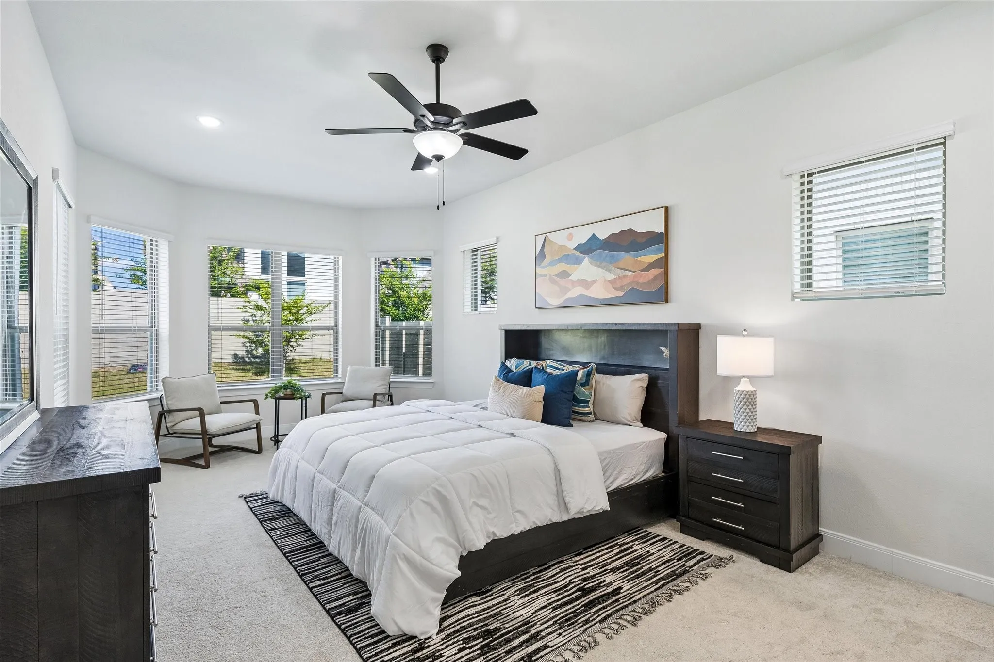Spacious room featuring light-toned carpeting and bright white walls