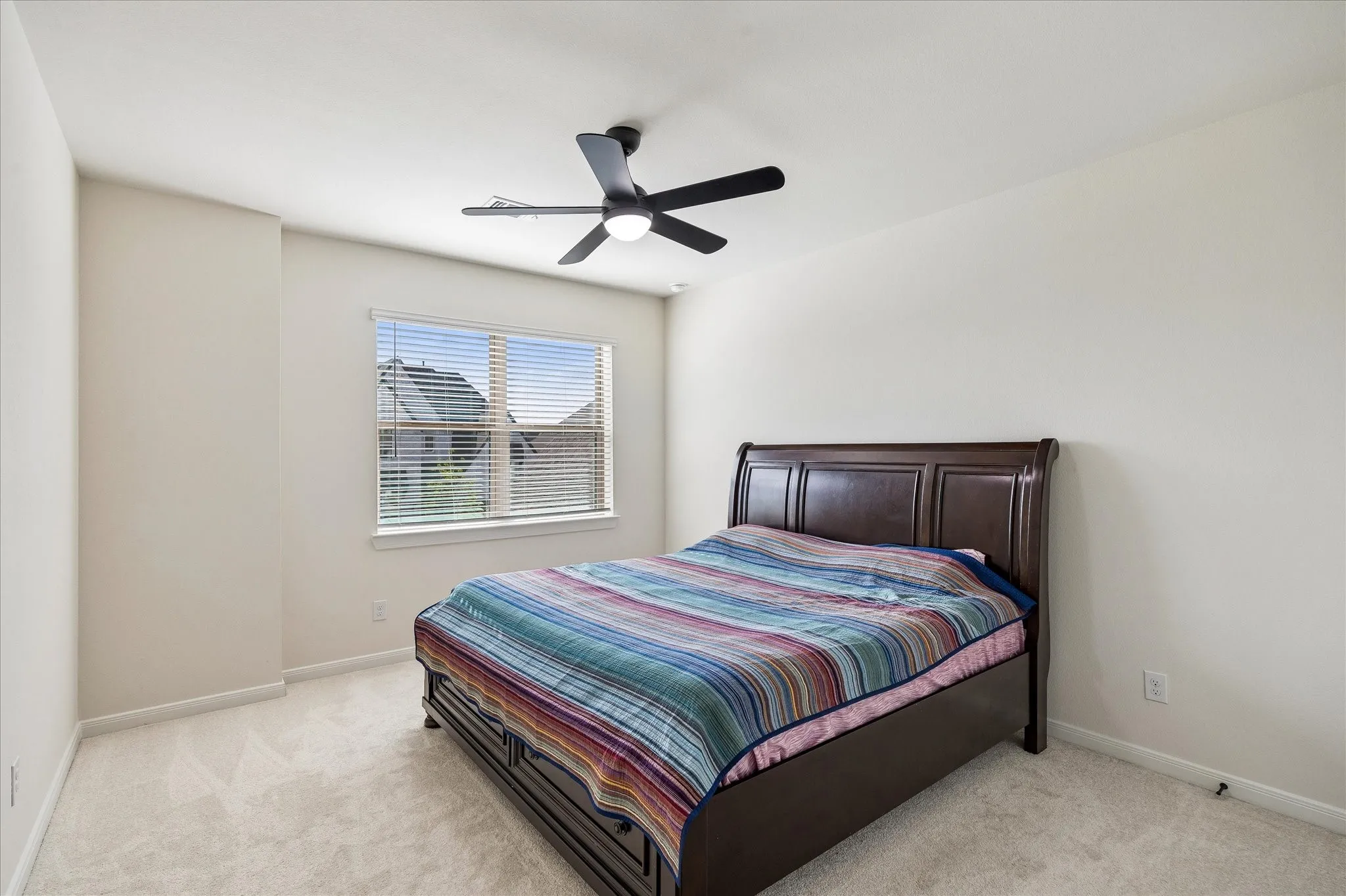 Bedroom featuring neutral-toned walls, white trim, and light-colored carpeting