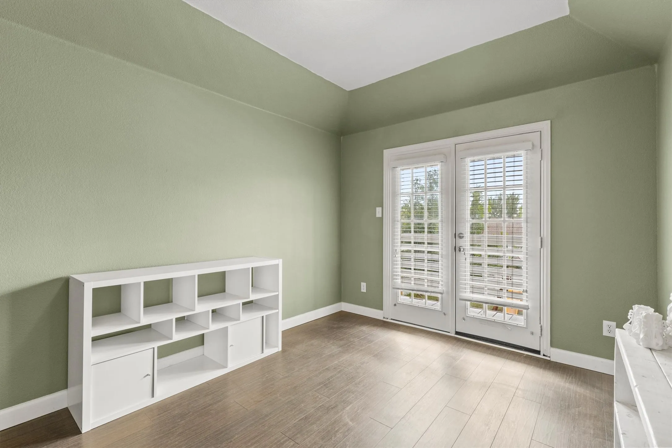 Bedroom with balcony overlooking the expansive backyard