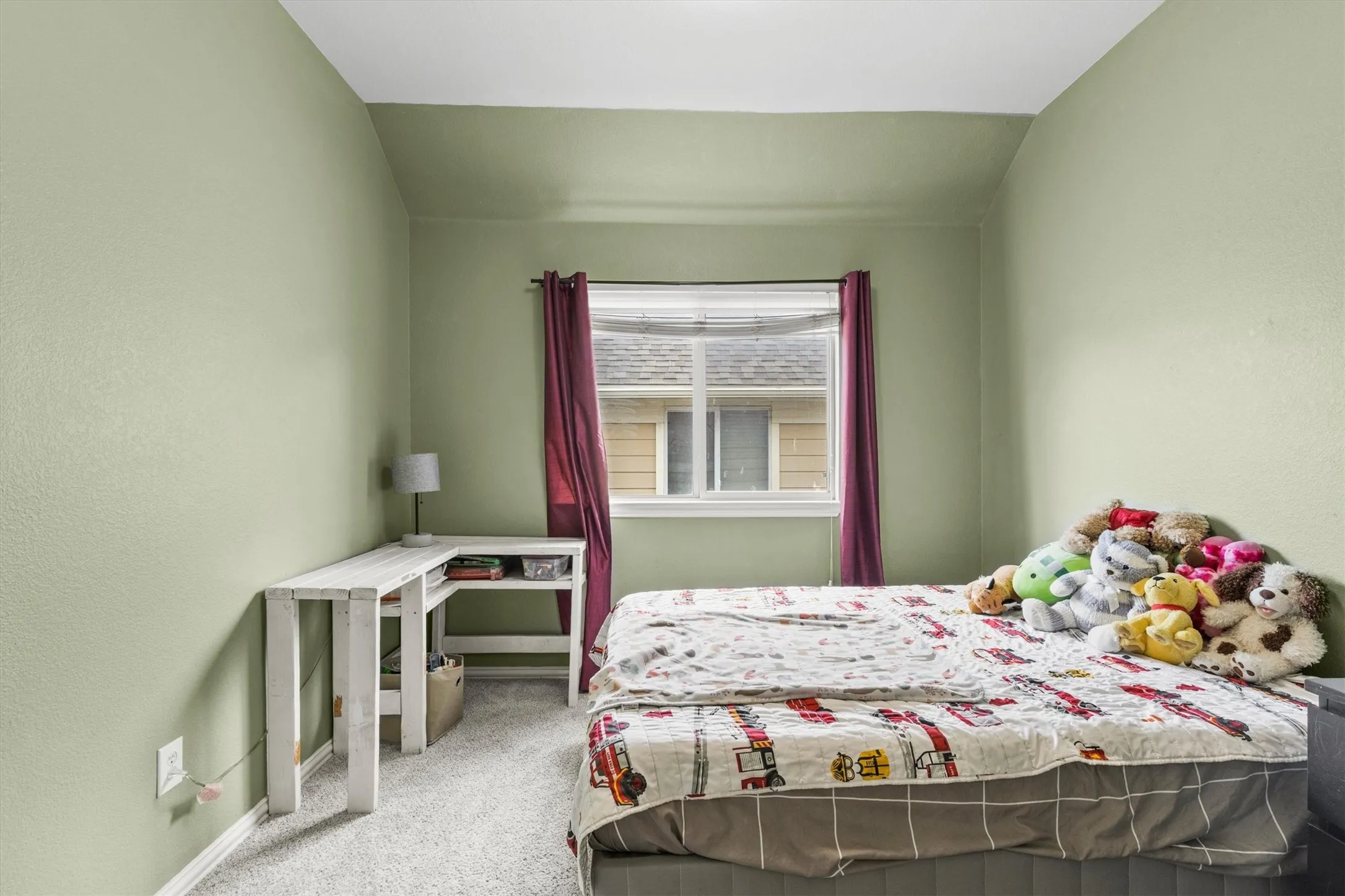 Room featuring light green wall paint and light-colored carpet flooring
