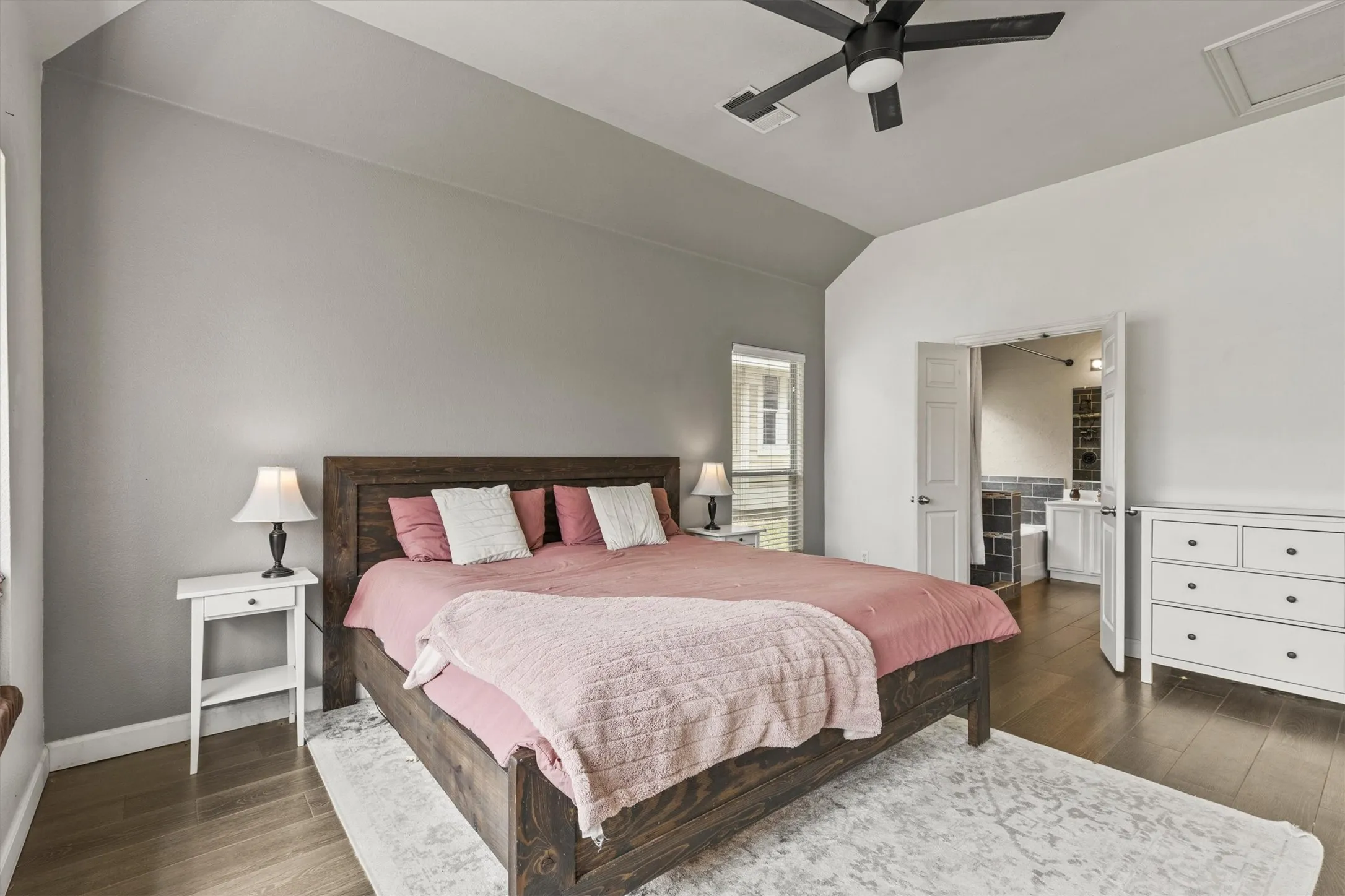 Hardwood-style flooring throughout, ceiling fan, and window with blinds