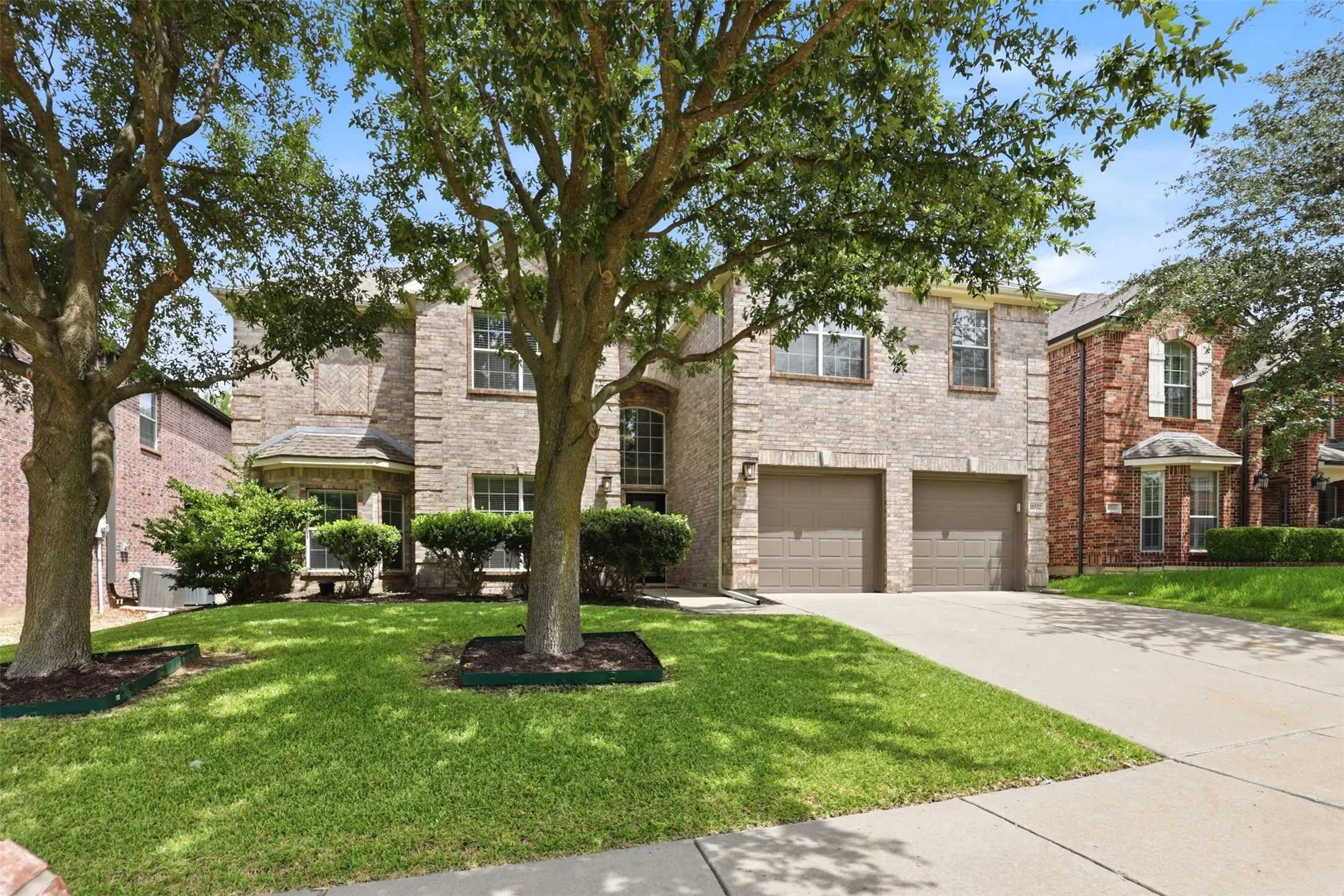 Beautiful landscaping and mature trees welcome you home!