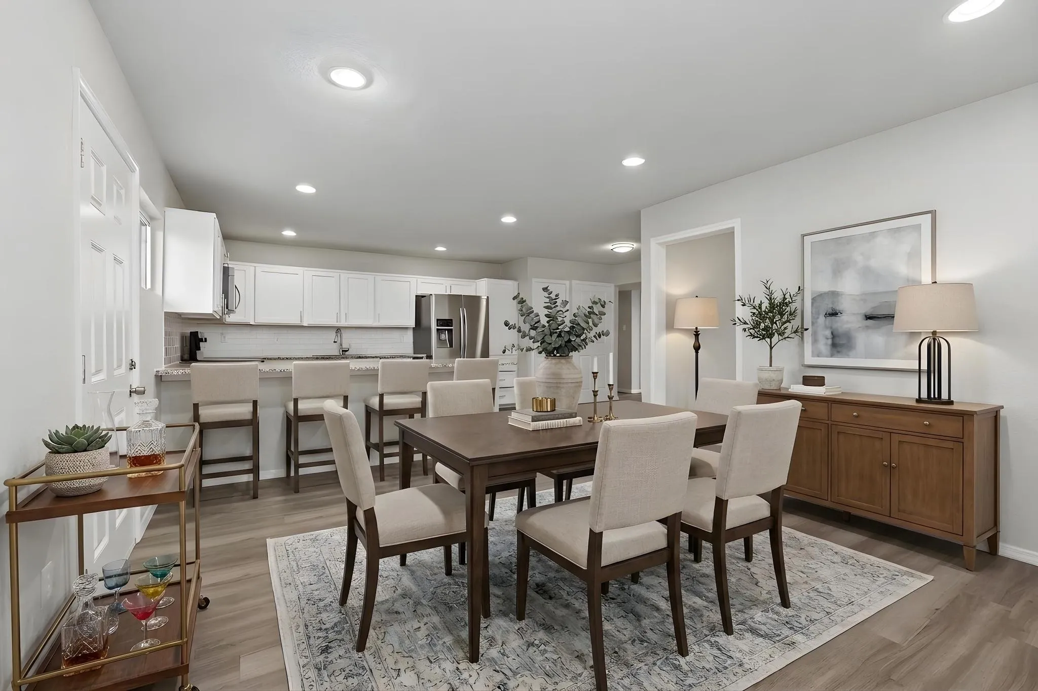 Open-concept living space featuring wood-finish flooring, recessed lighting, and a neutral color palette