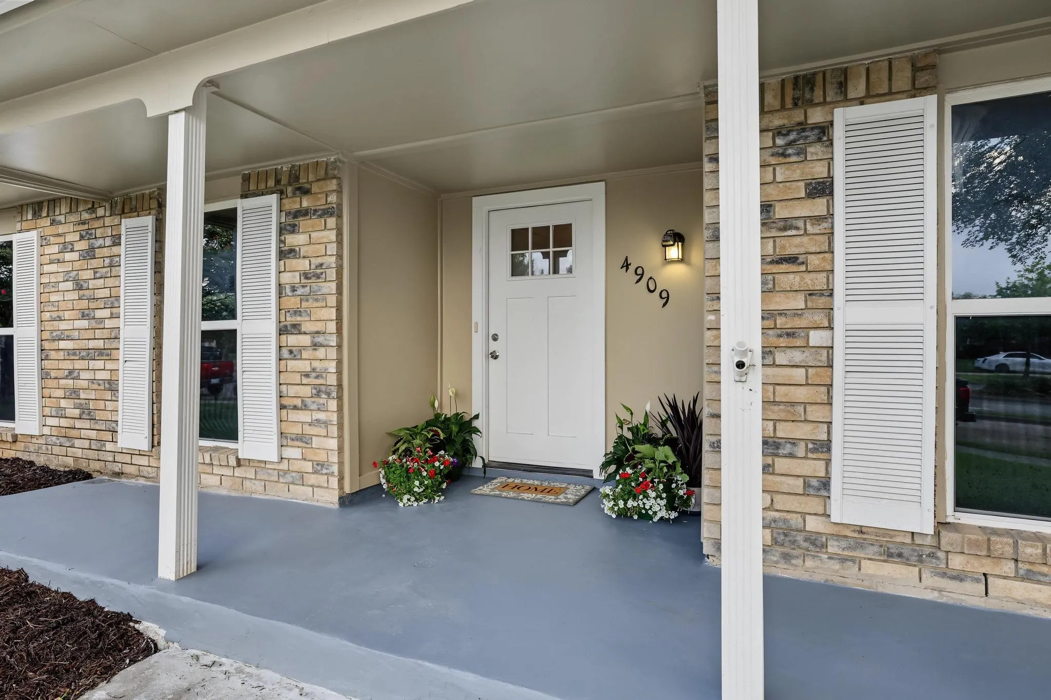 Brick facade with white louvered shutters